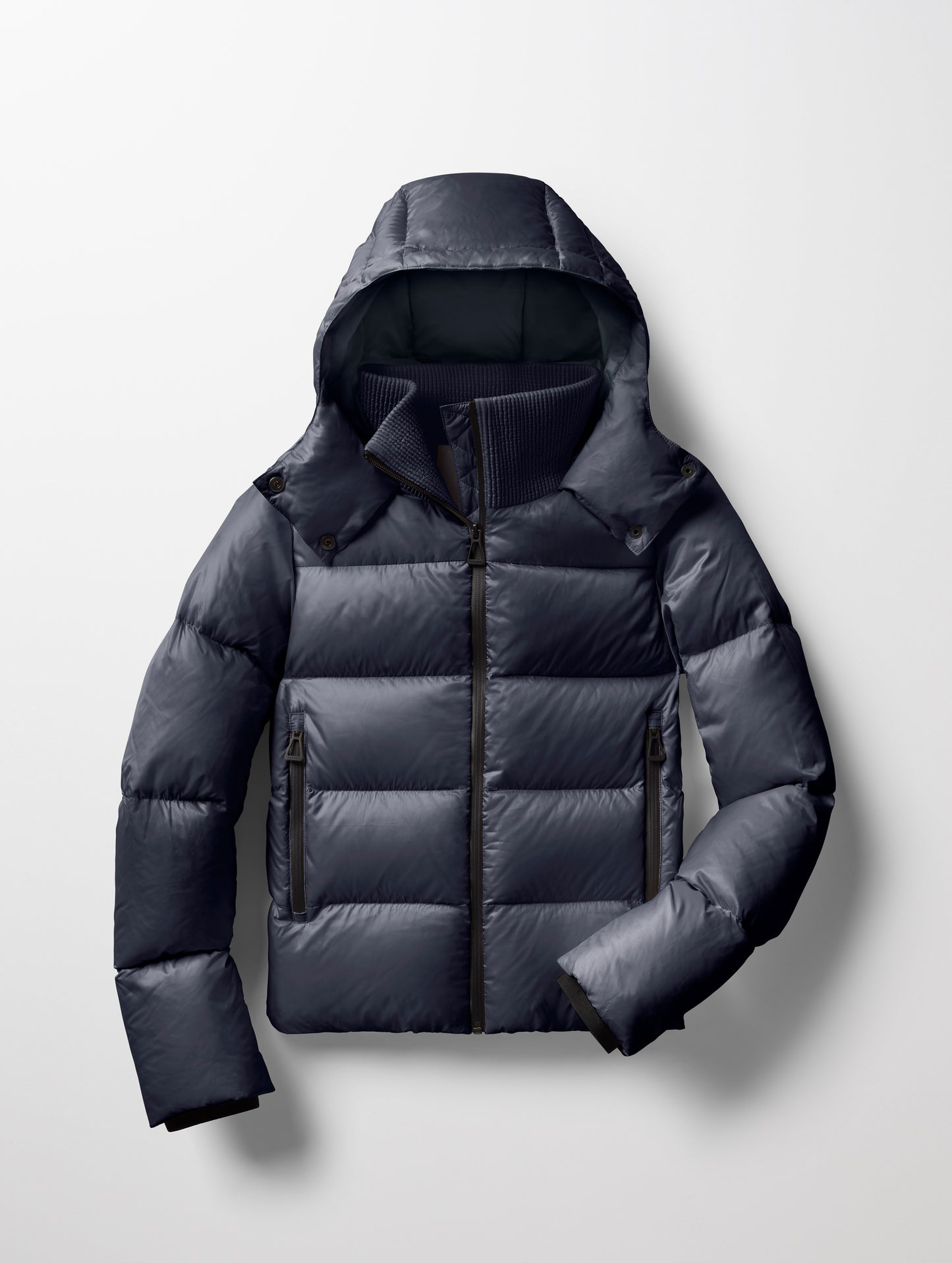Flat lay of Aura Puffer Jacket in Total Eclipse dark blue from AETHER Apparel.