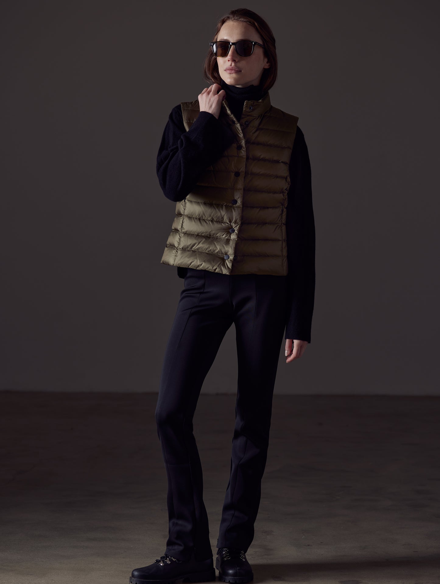 Front full-body view of woman wearing Aura Vest in Command Green from AETHER Apparel.