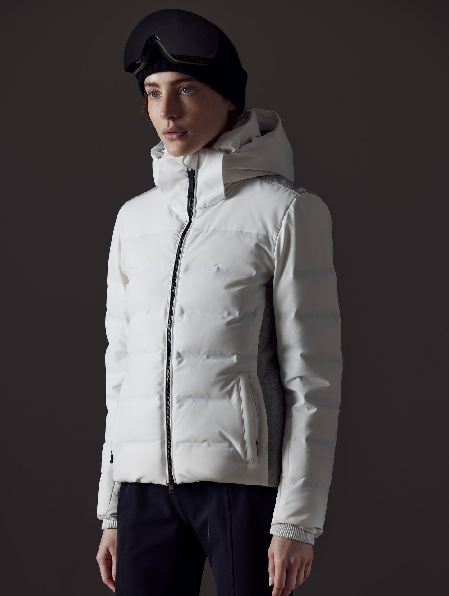 Front left angled view of woman wearing Bancroft Snow Jacket in White from AETHER Apparel.