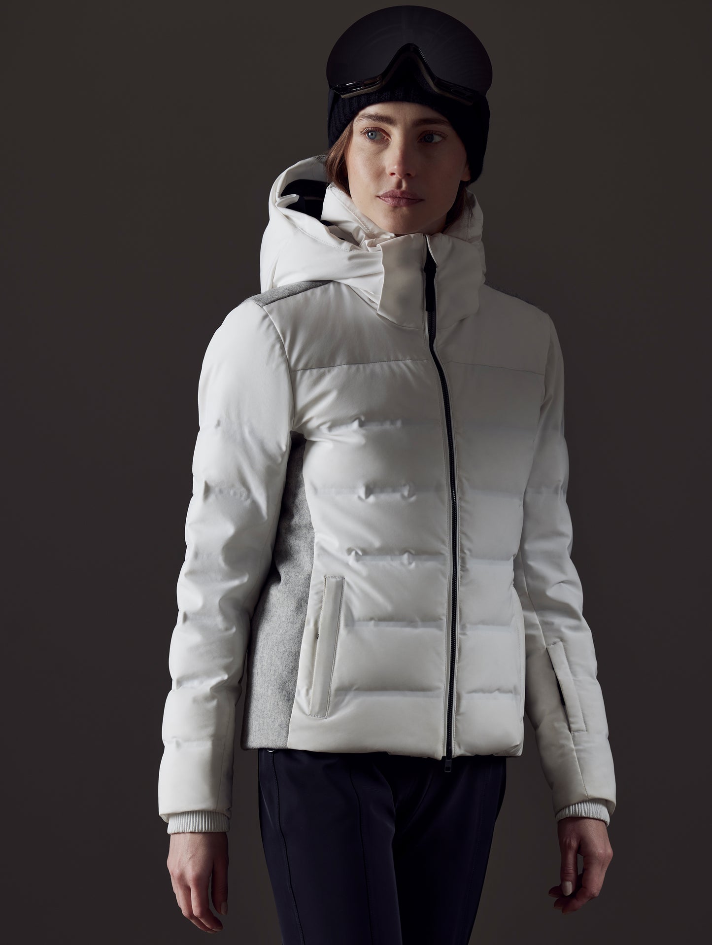 Front right angled view of woman wearing Bancroft Snow Jacket in White from AETHER Apparel.