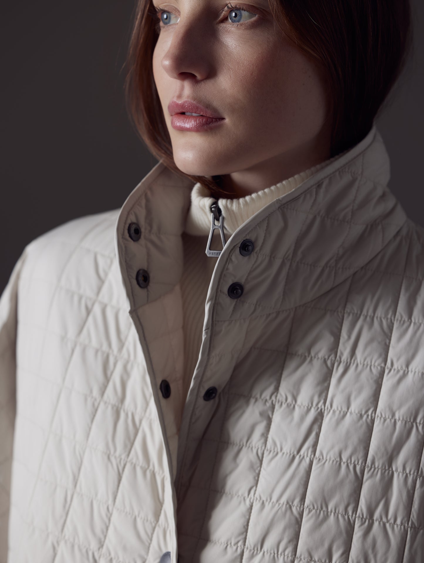 Woman wearing beige Bardo Poncho Jacket from AETHER Apparel