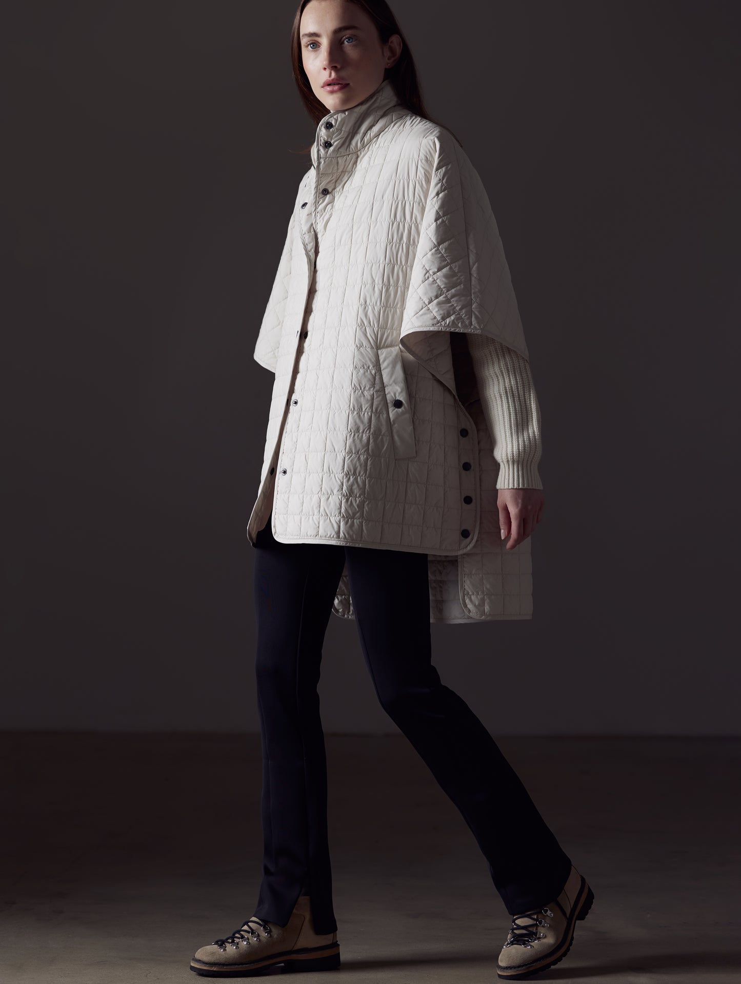 Woman wearing beige Bardo Poncho Jacket from AETHER Apparel