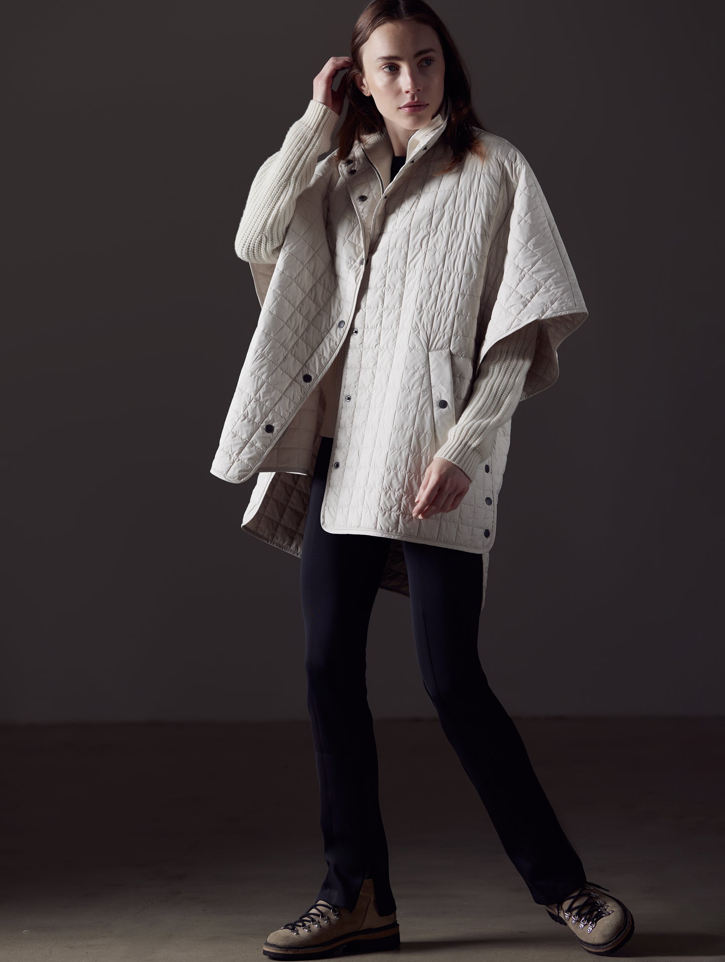 Woman wearing beige Bardo Poncho Jacket from AETHER Apparel