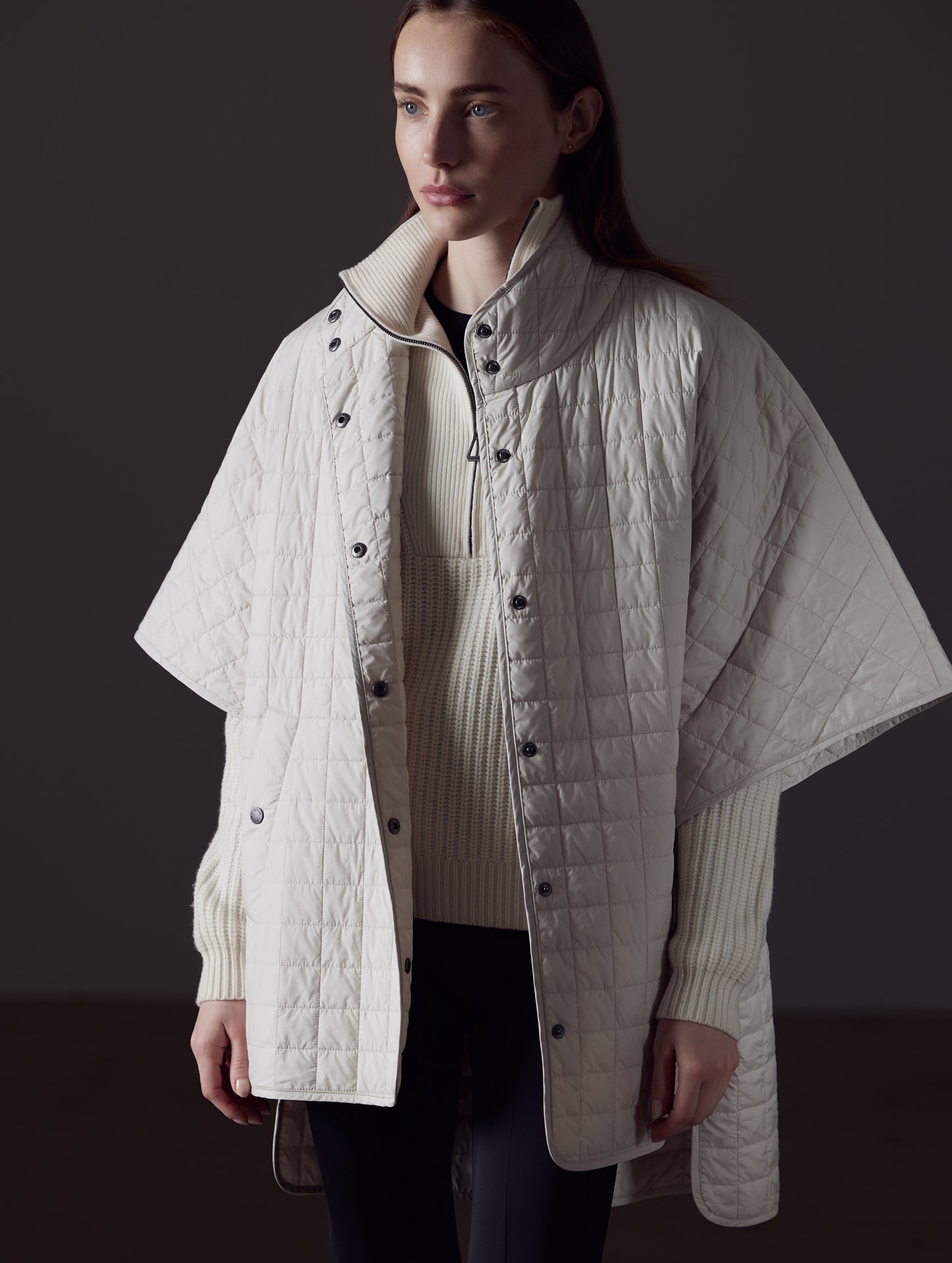 Woman wearing beige Bardo Poncho Jacket from AETHER Apparel