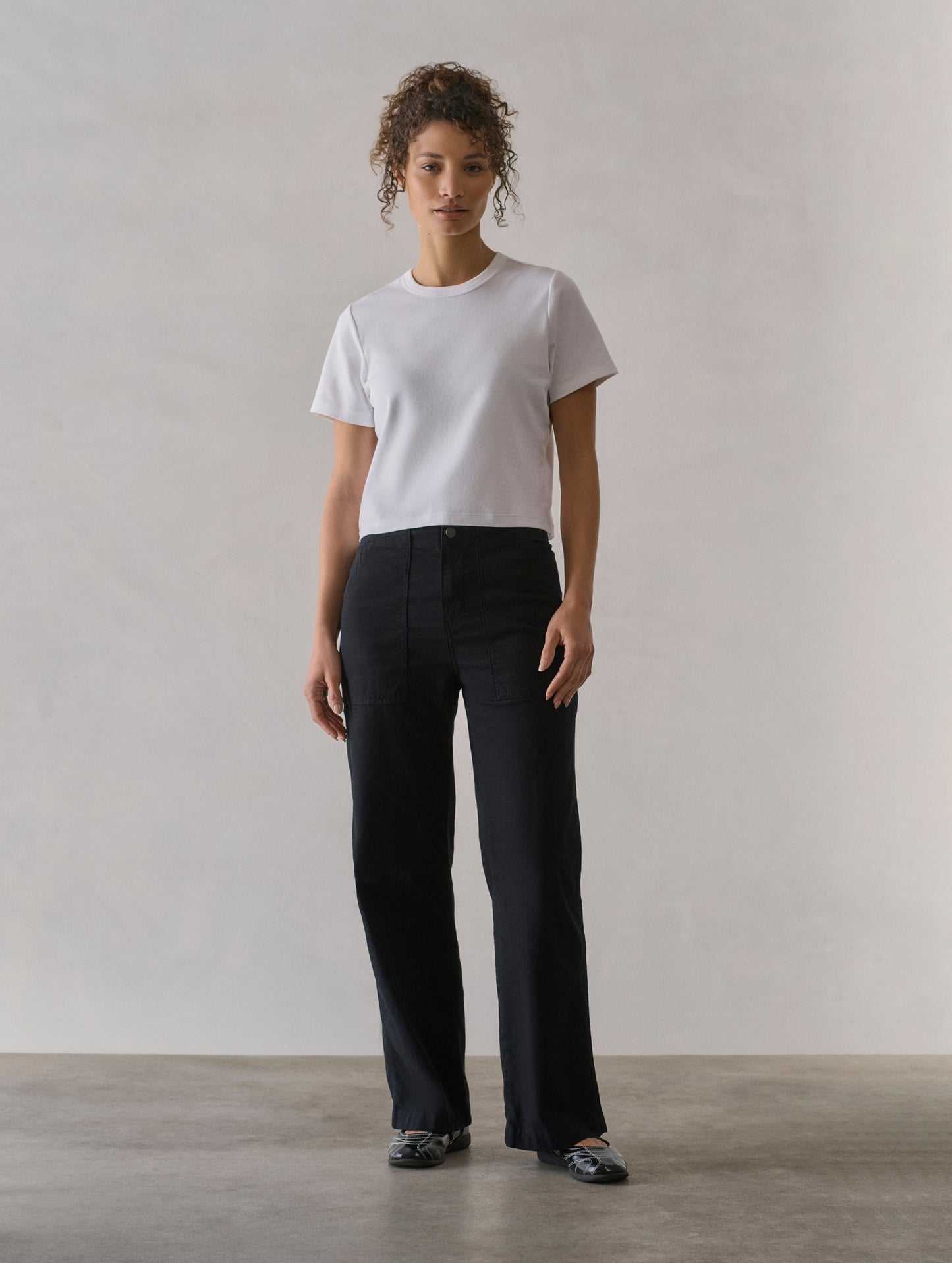 Front full body view of woman wearing Bella Travel Pant in Onyx Black from AETHER Apparel.