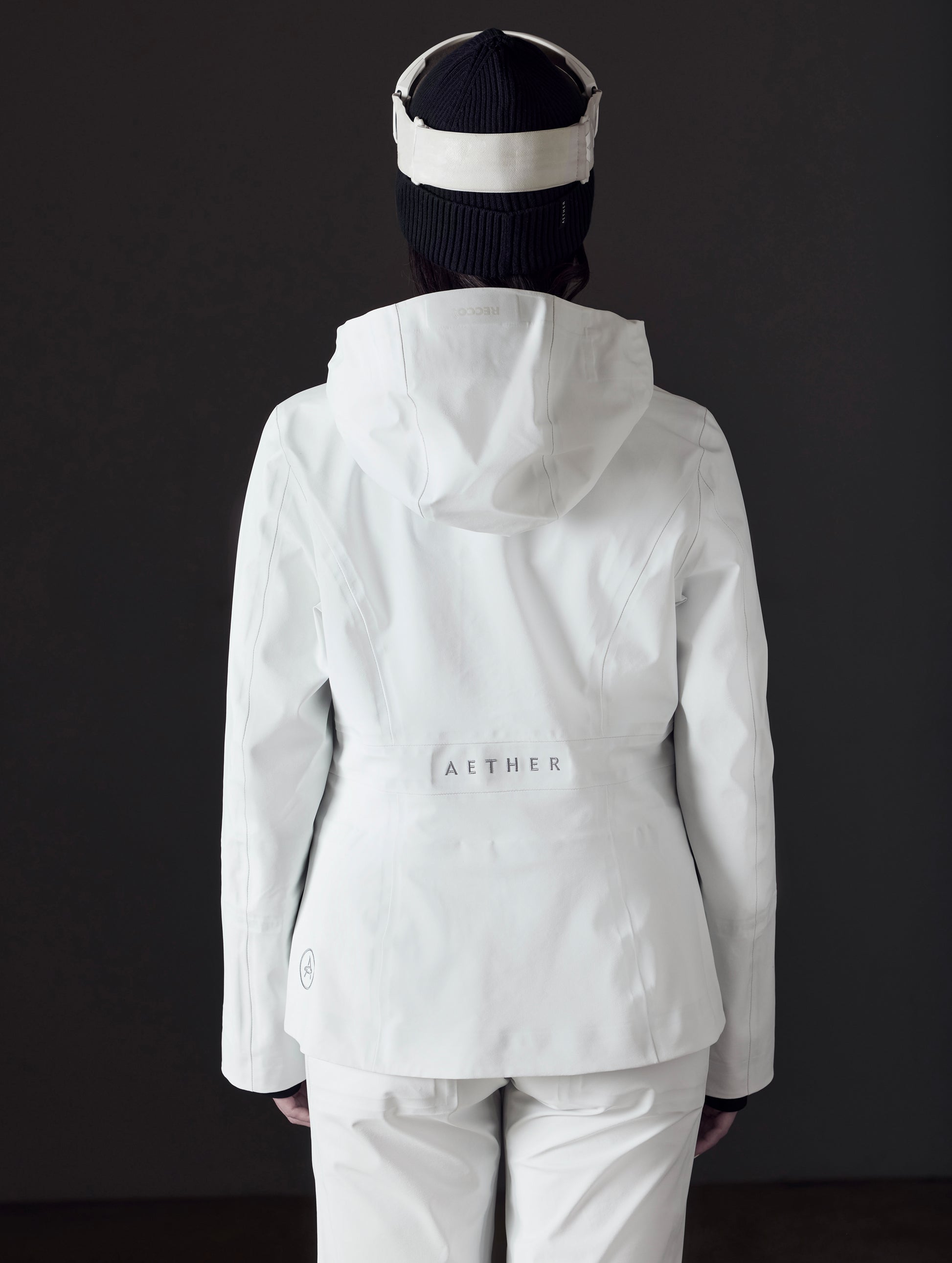Rear view of woman wearing Boyd Snow Jacket in White from AETHER Apparel.