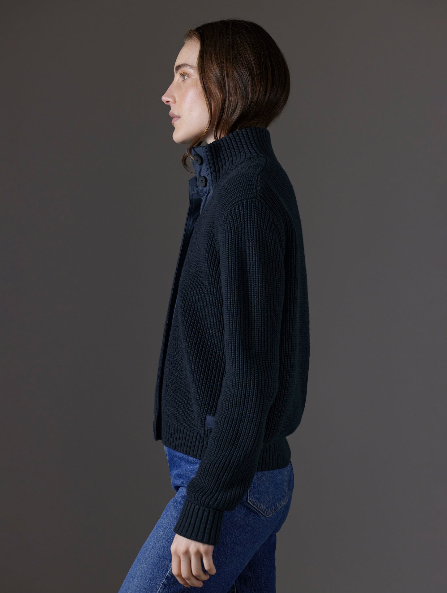 Side profile view of woman wearing Cato Buttoned Sweater in Total Eclipse dark blue from AETHER Apparel.