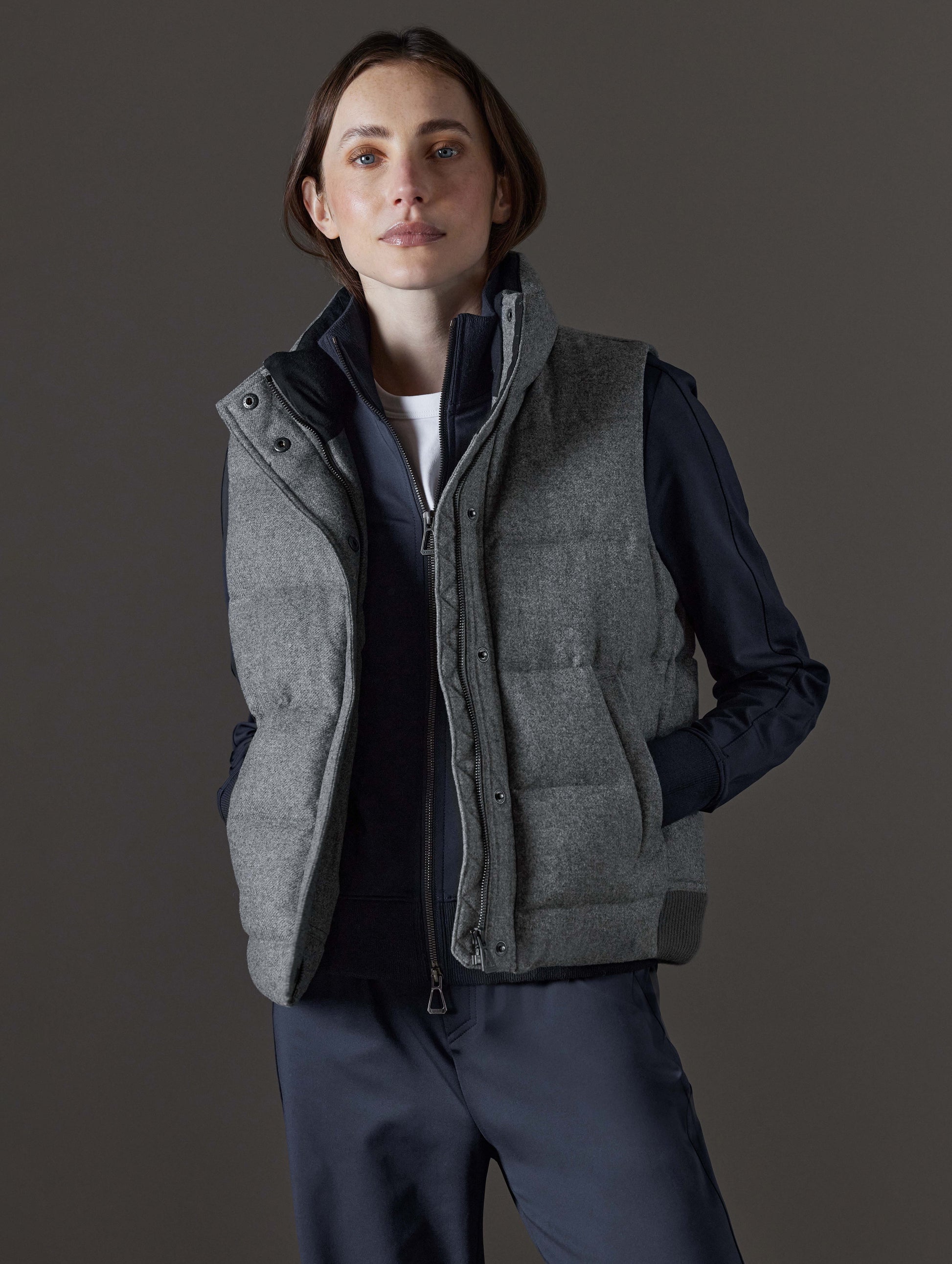 Front angled view of woman wearing Channing Vest 2.0 in Heather Grey from AETHER Apparel.