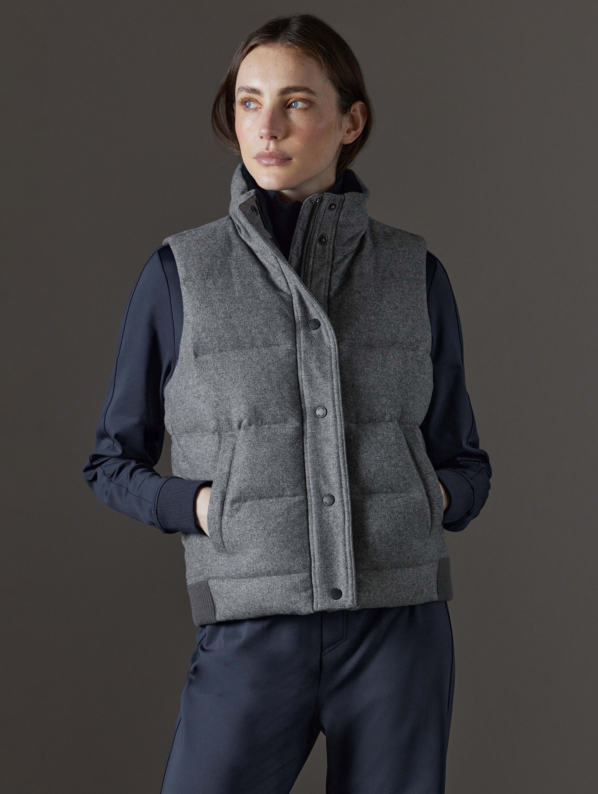 Front view of woman wearing Channing Vest 2.0 in Heather Grey from AETHER Apparel.