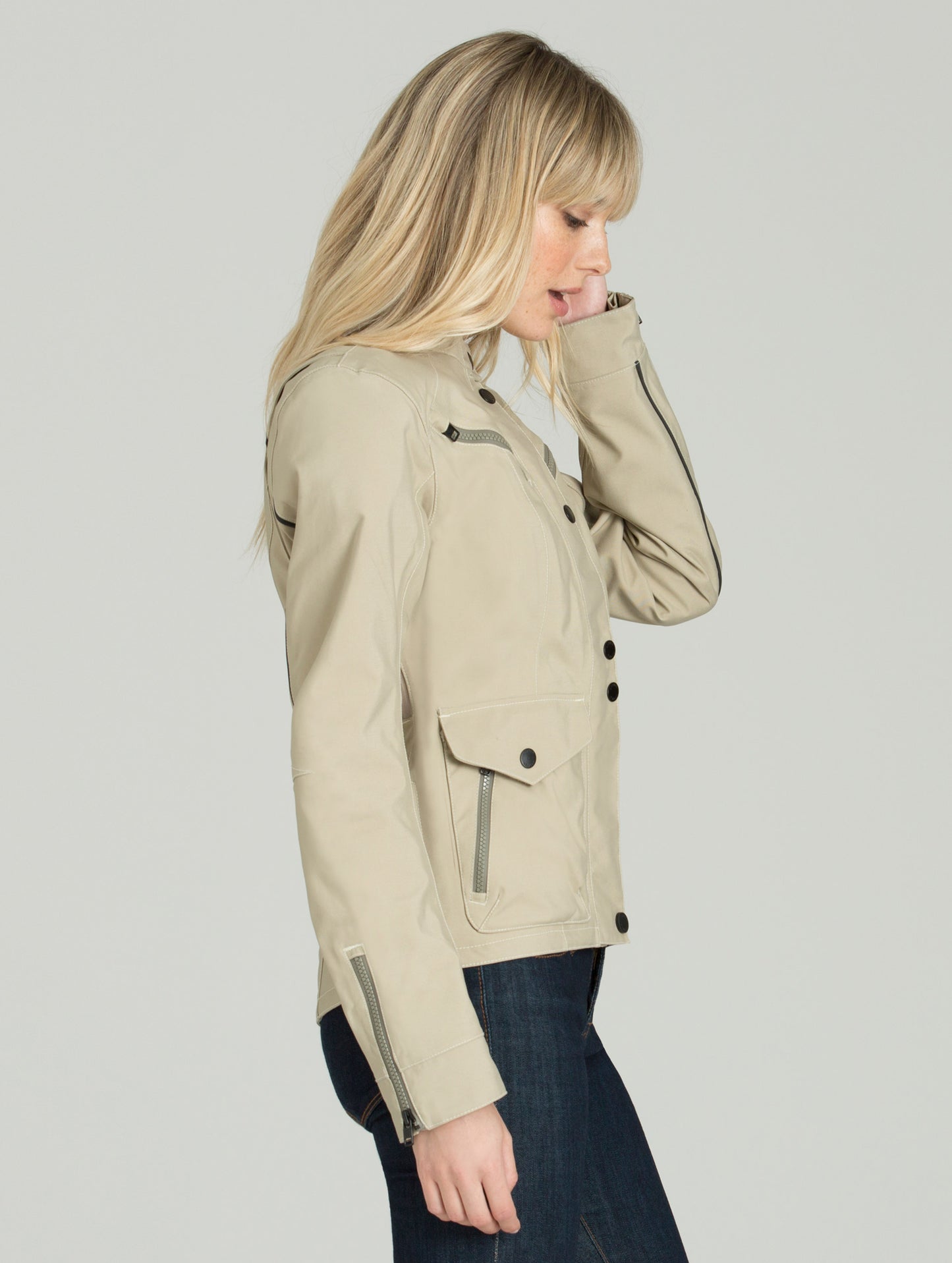 Side view of woman wearing sand Chase Motorcycle Jacket.