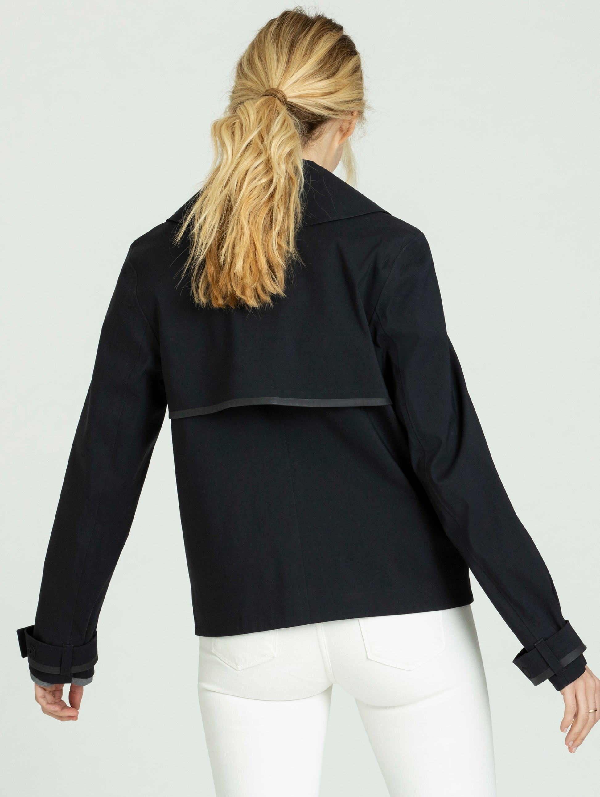 Back view of woman wearing black Cole Jacket from AETHER Apparel.