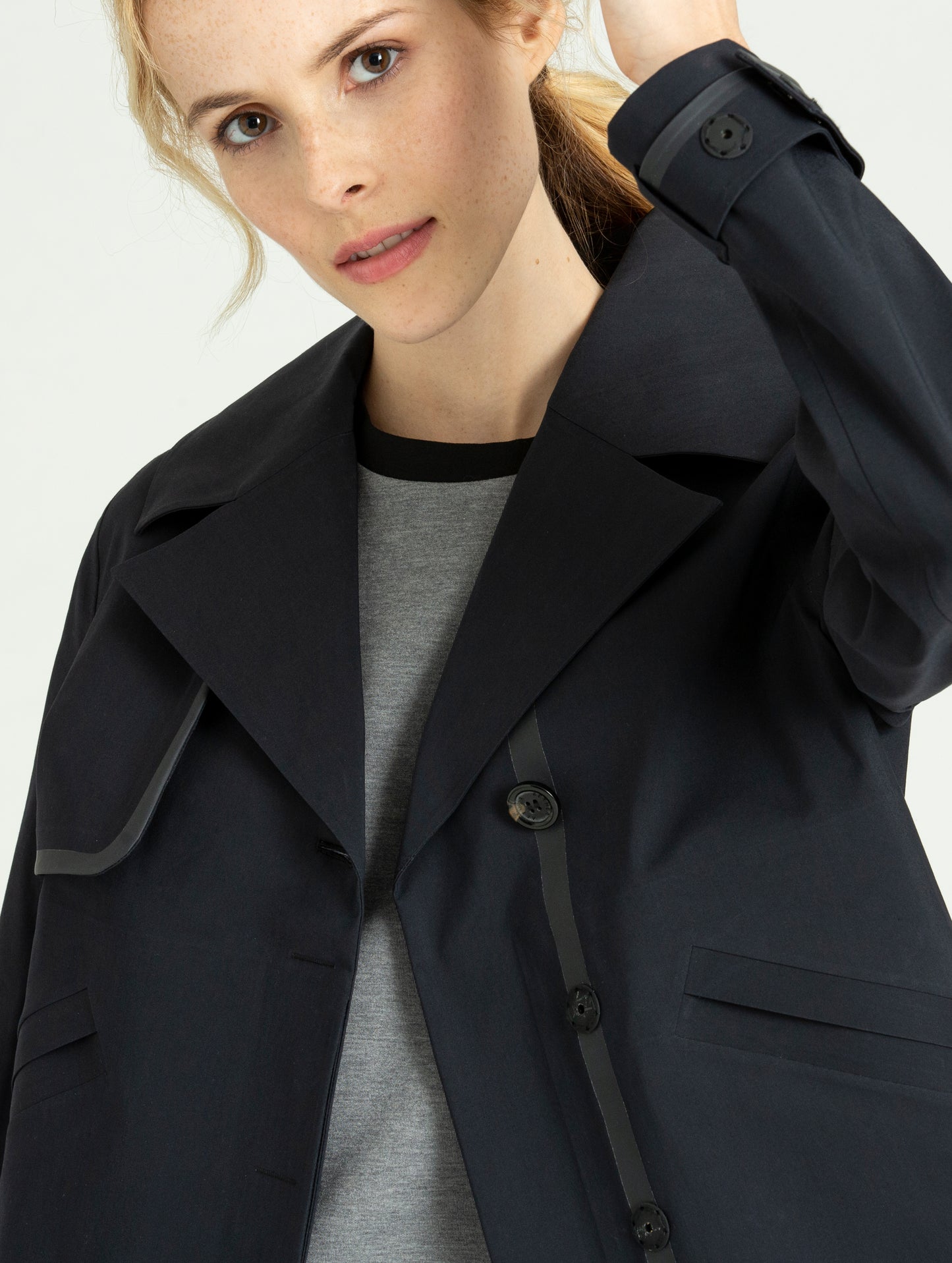 Close front view of woman wearing black Cole Jacket from AETHER Apparel.