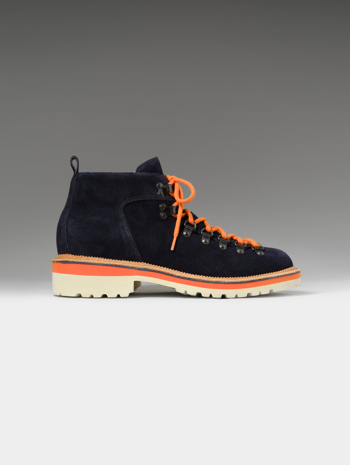 Side profile studio shot of the W Dolomite Boot in Total Eclipse with orange laces from AETHER Apparel.