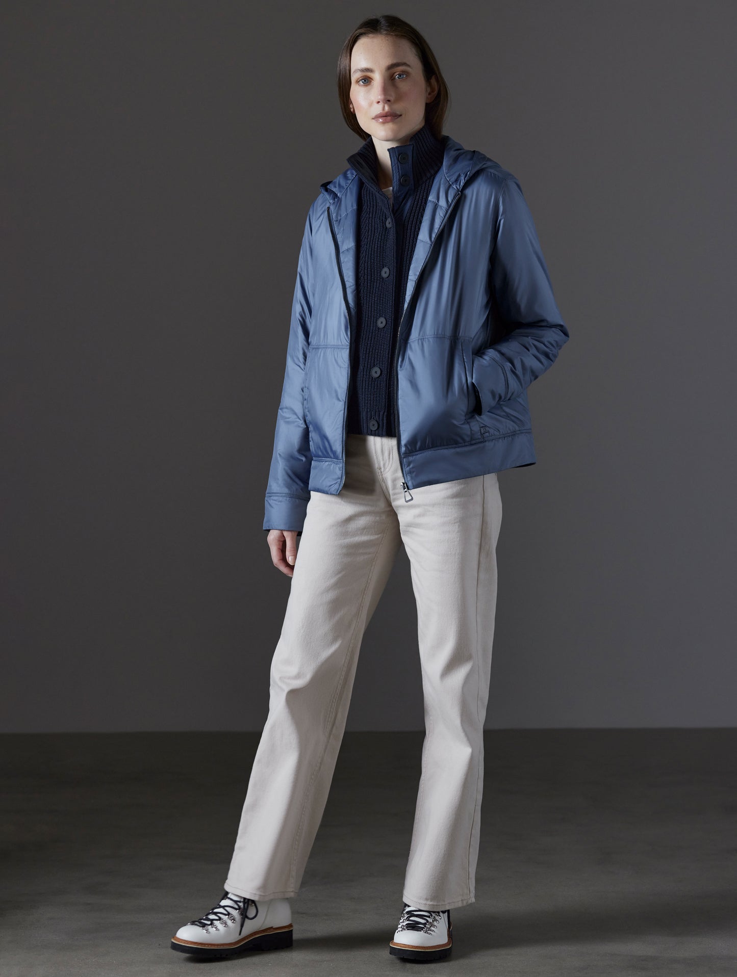Front angled full-body view of woman wearing Eco Space Hoodie in Portal Blue from AETHER Apparel.