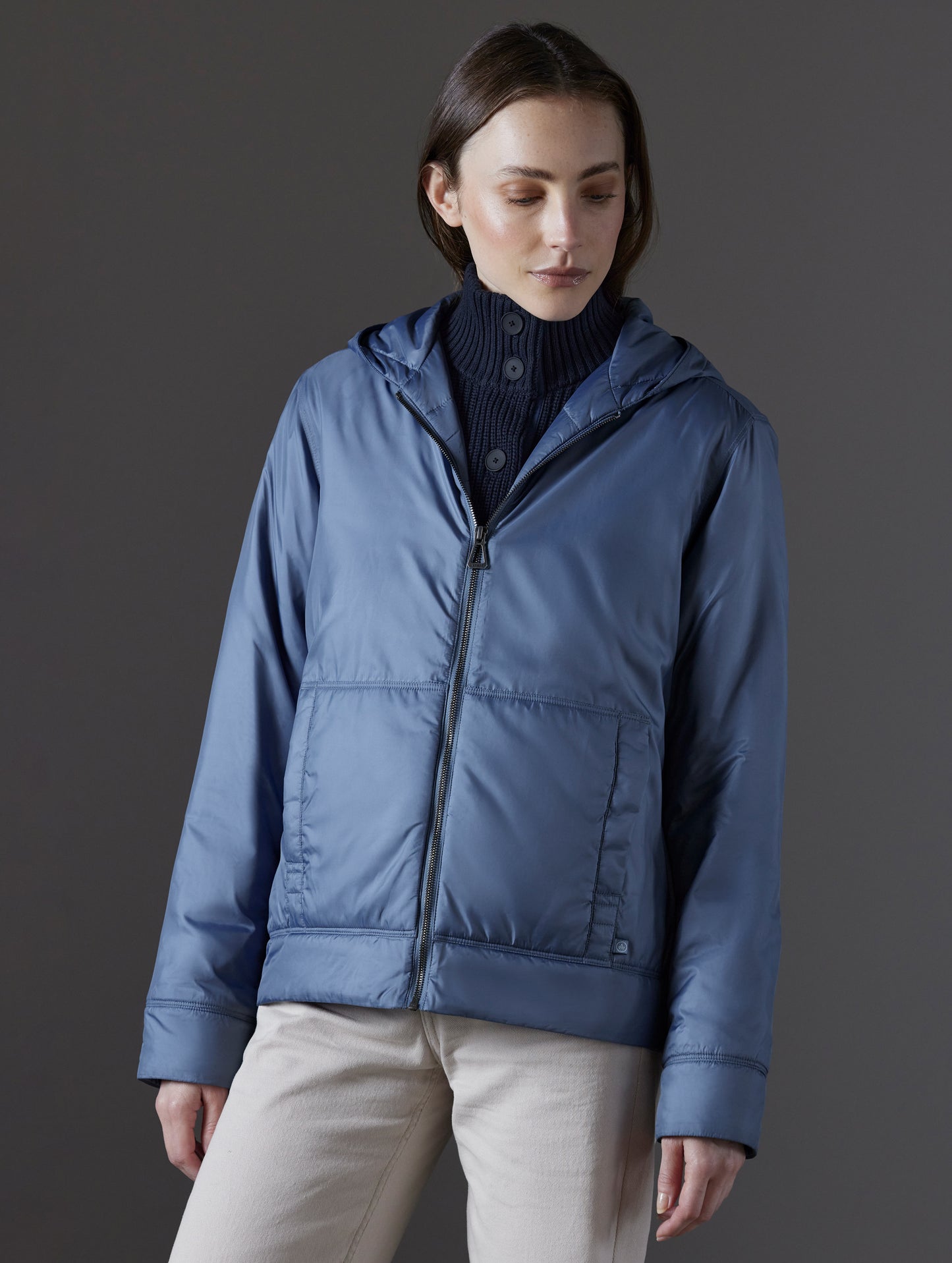 Front body view of woman wearing Eco Space Hoodie in Portal Blue from AETHER Apparel.