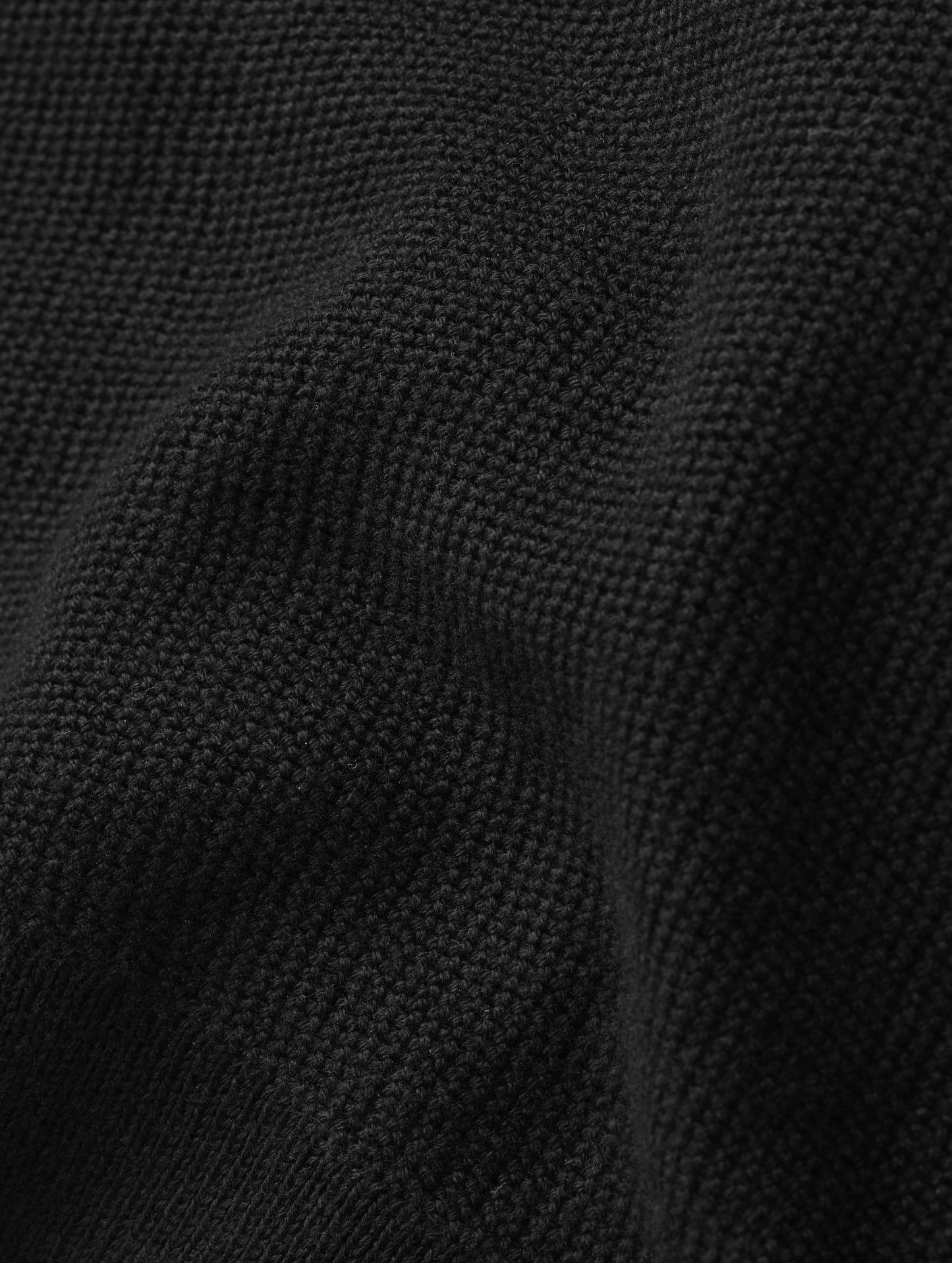 Closeup detailed view of the fabric on the Eliana Sweater Tee in Onyx Black from AETHER Apparel.