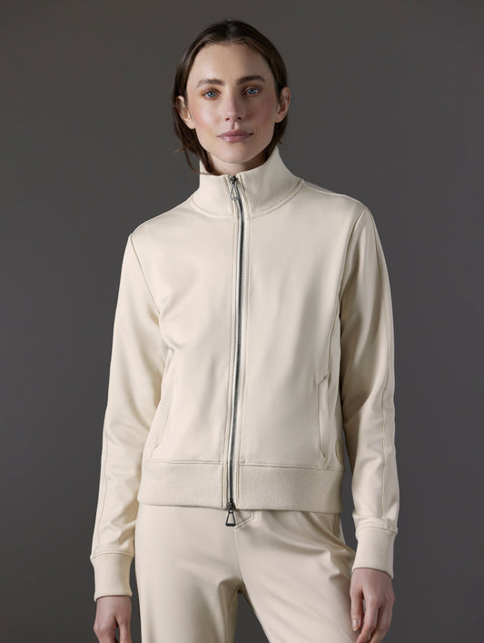 Front view of woman wearing Eloise Travel Jacket in Bone white from AETHER Apparel.