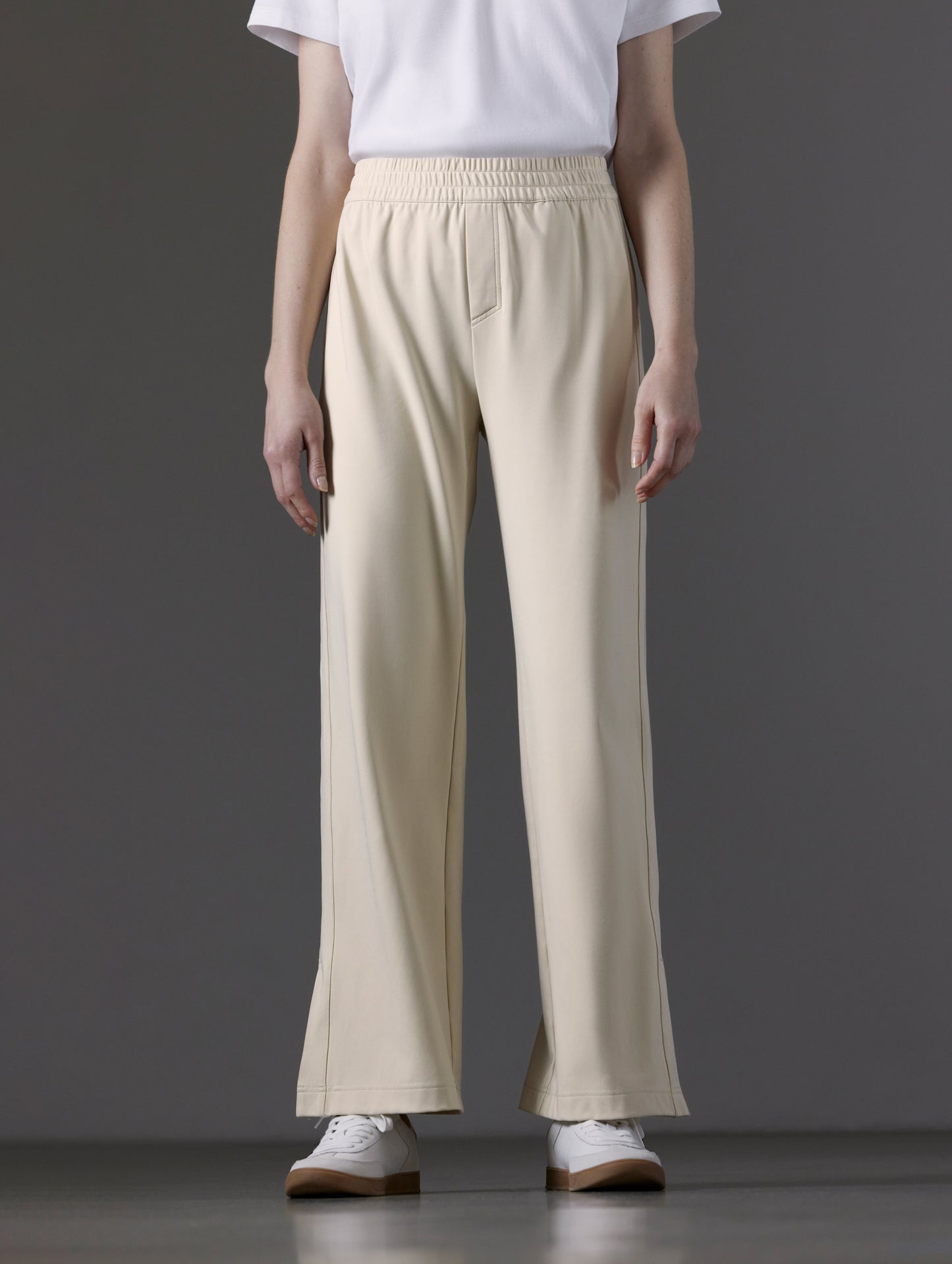 Front lower body view of woman wearing Eloise Travel Slim Pant in Bone white from AETHER Apparel.