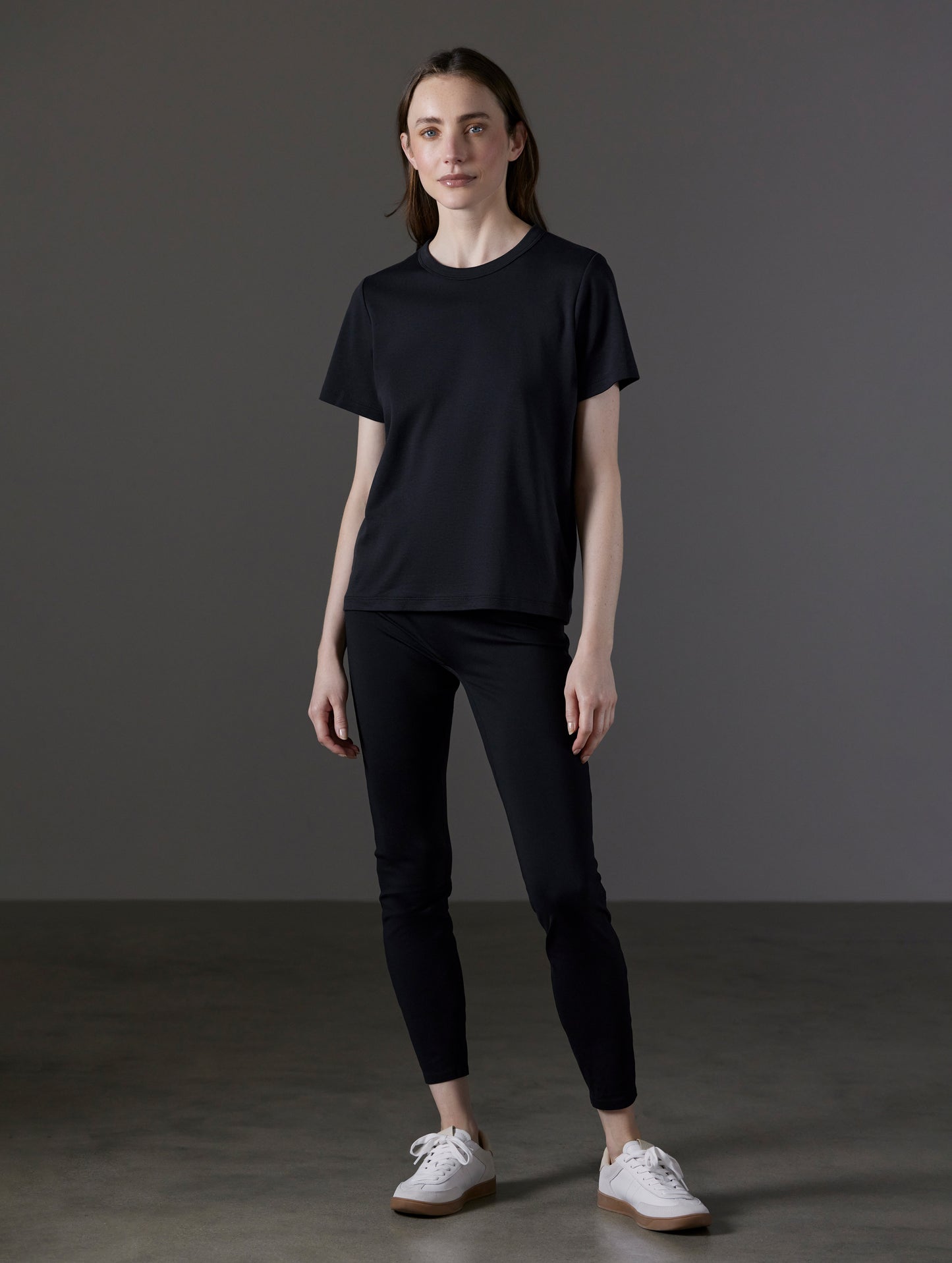 Front full-body view of woman wearing Emery Pima Tee in Onyx Black from AETHER Apparel.