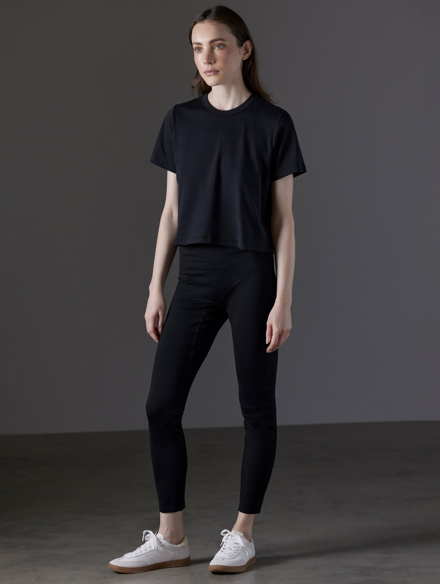 Front angled full-body view of woman wearing Emery Pima Cropped Tee in Onyx Black from AETHER Apparel.