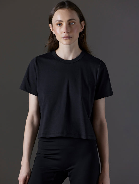 Front view of woman wearing Emery Pima Cropped Tee in Onyx Black from AETHER Apparel.