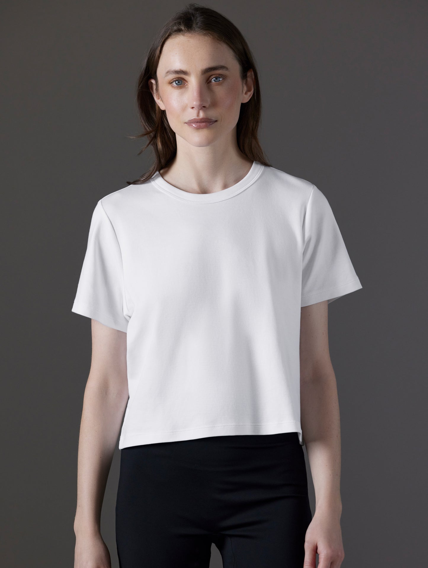 Front view of woman wearing Emery Pima Cropped Tee in White from AETHER Apparel.