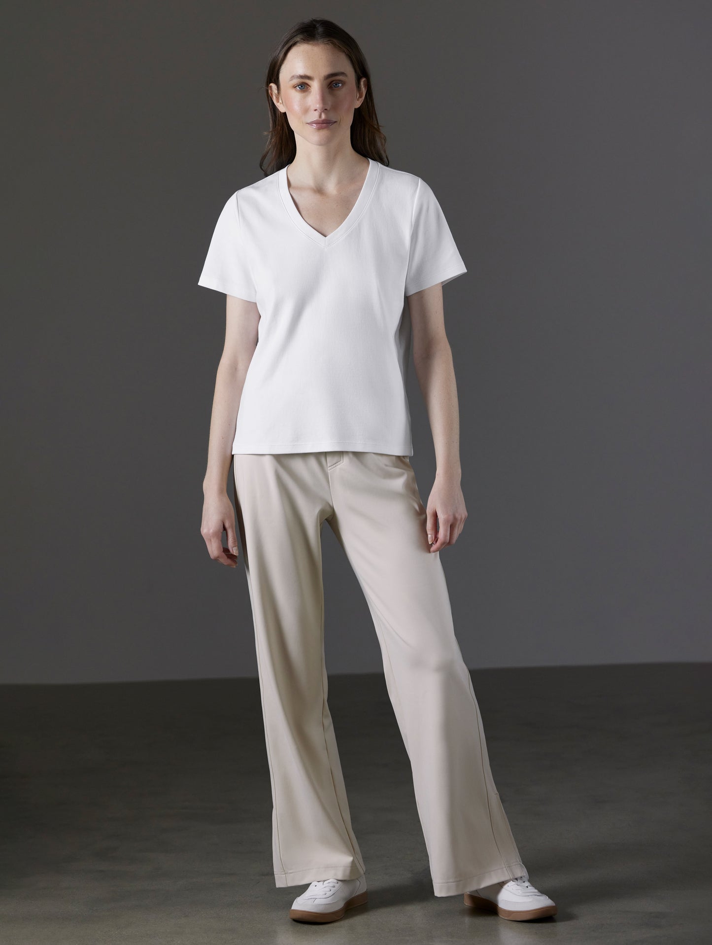 Front full-body view of woman wearing Emery Pima V-Neck Tee in White from AETHER Apparel.