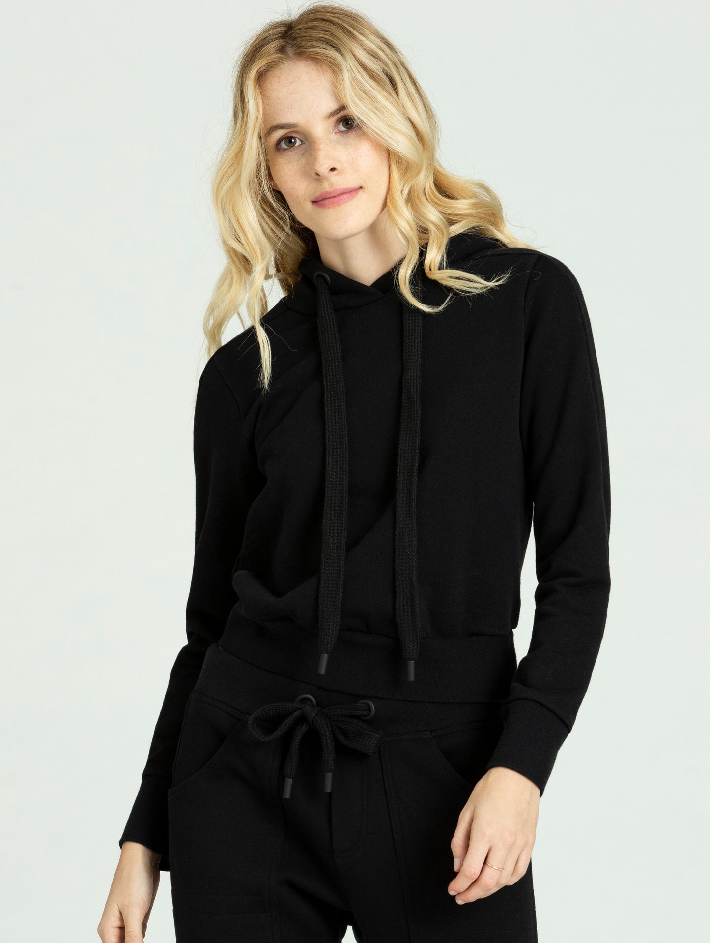 Woman wearing black Journey Pullover from AETHER Apparel.