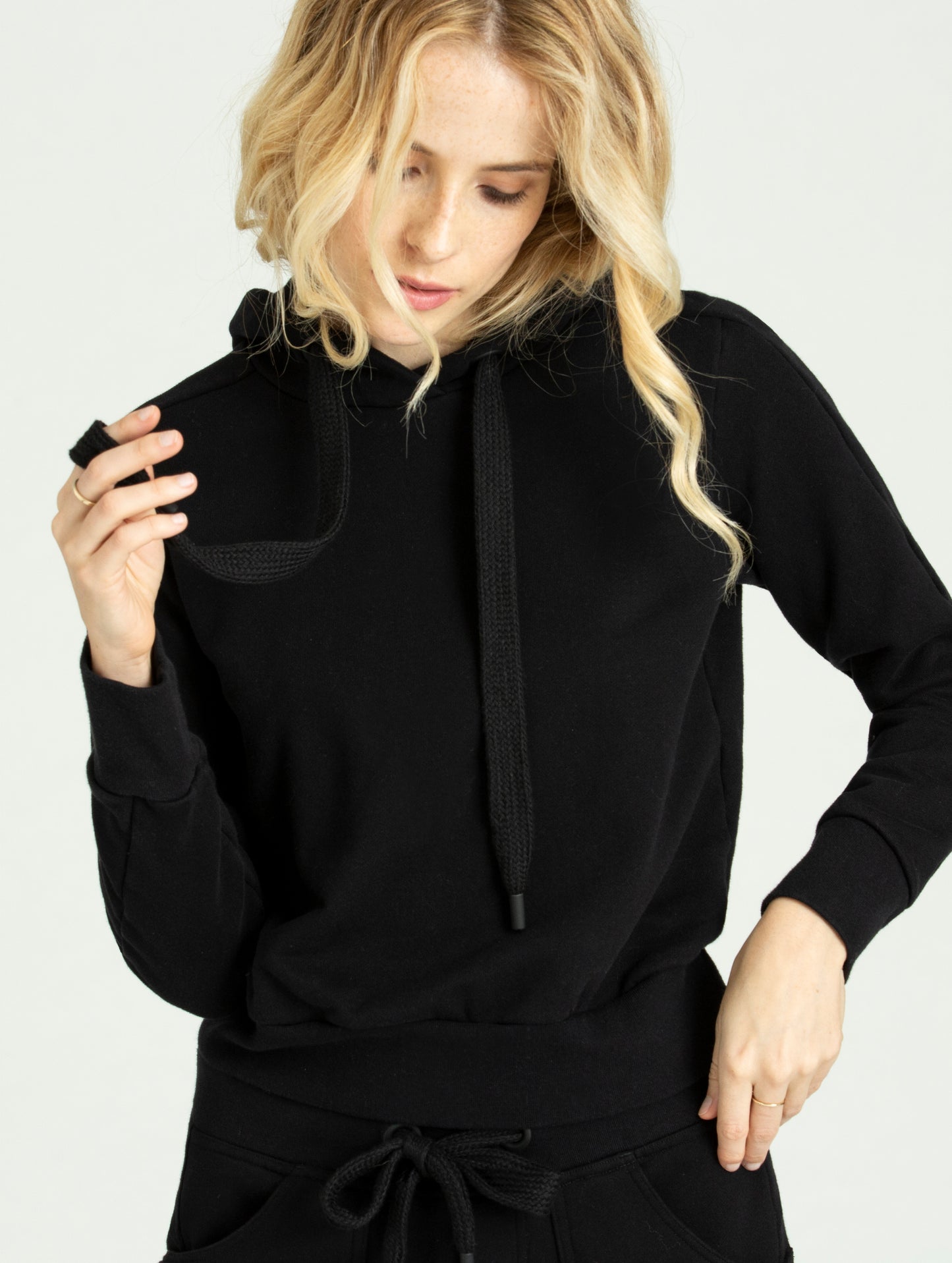 Woman wearing black Journey Pullover from AETHER Apparel.