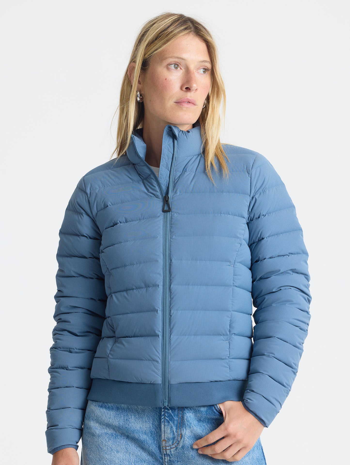 Front view of woman wearing W Launch Full-Zip Jacket NH in Portal Blue from AETHER Apparel.