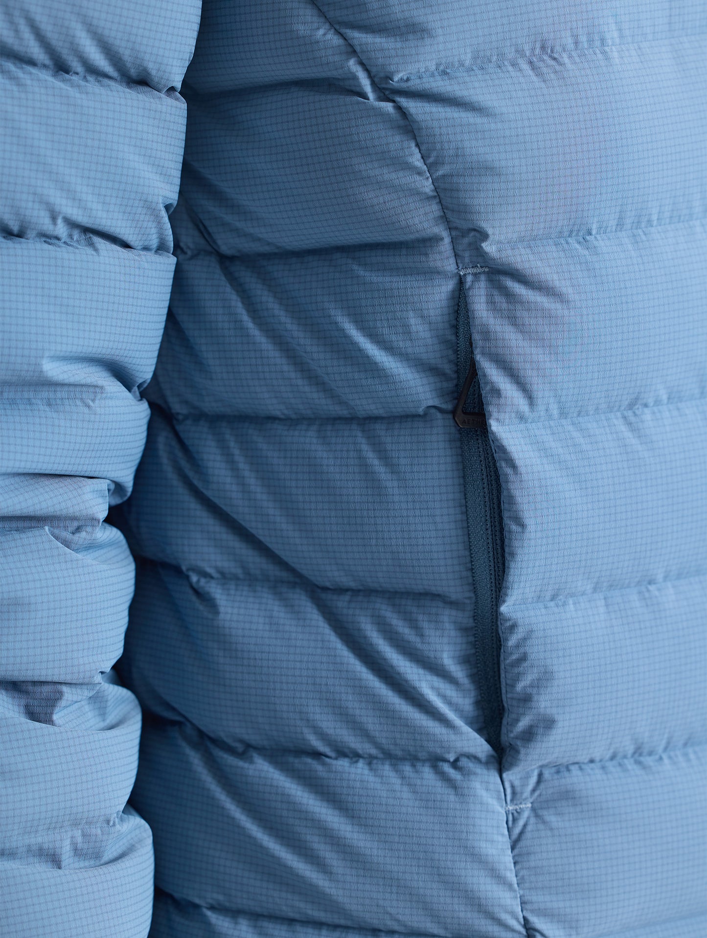 Closeup detail view of wearer's right pocket of W Launch Full-Zip Jacket NH in Portal Blue from AETHER Apparel.