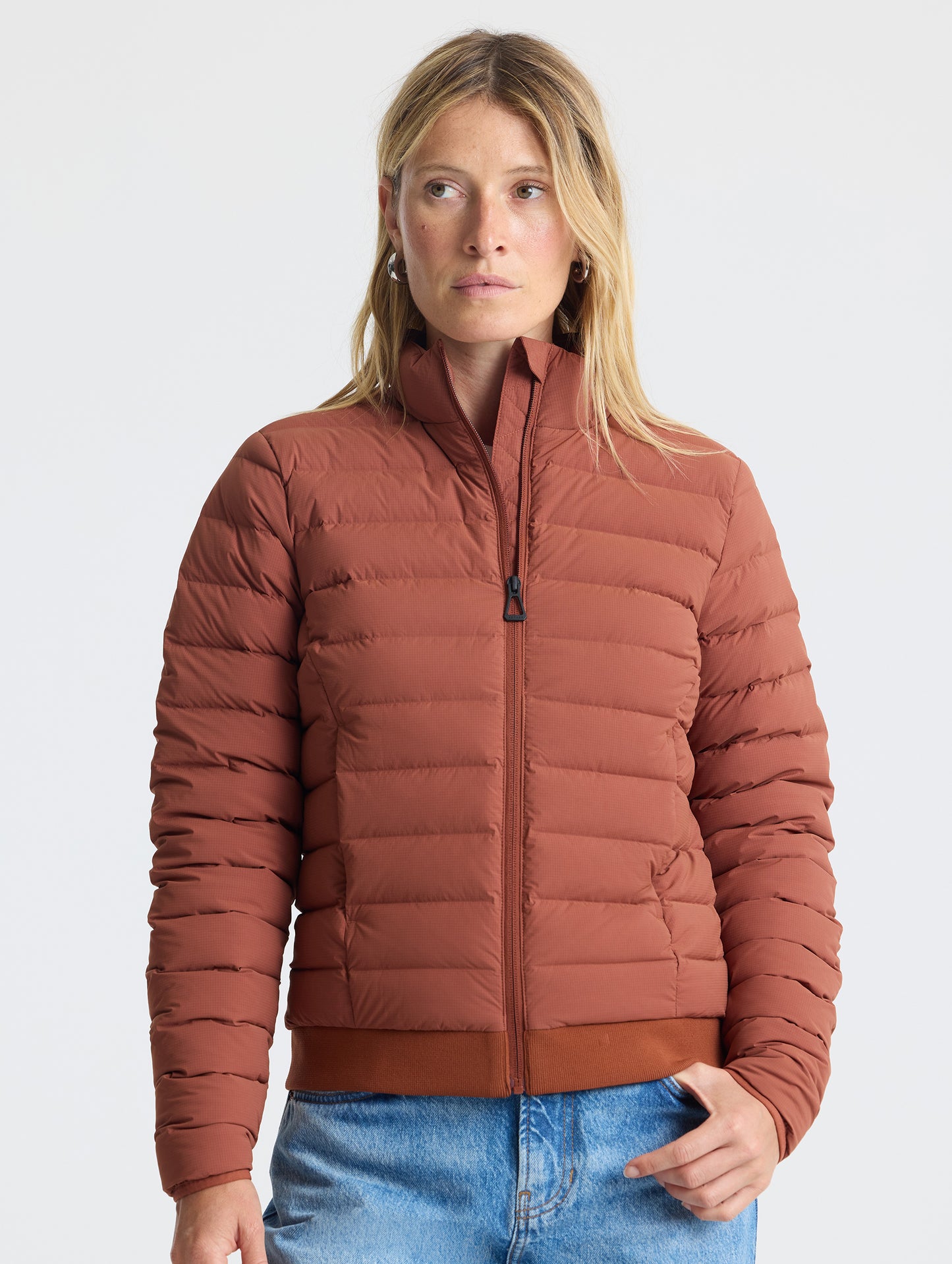 Front view of woman wearing W Launch Full-Zip Jacket NH in Redwood Rust from AETHER Apparel.