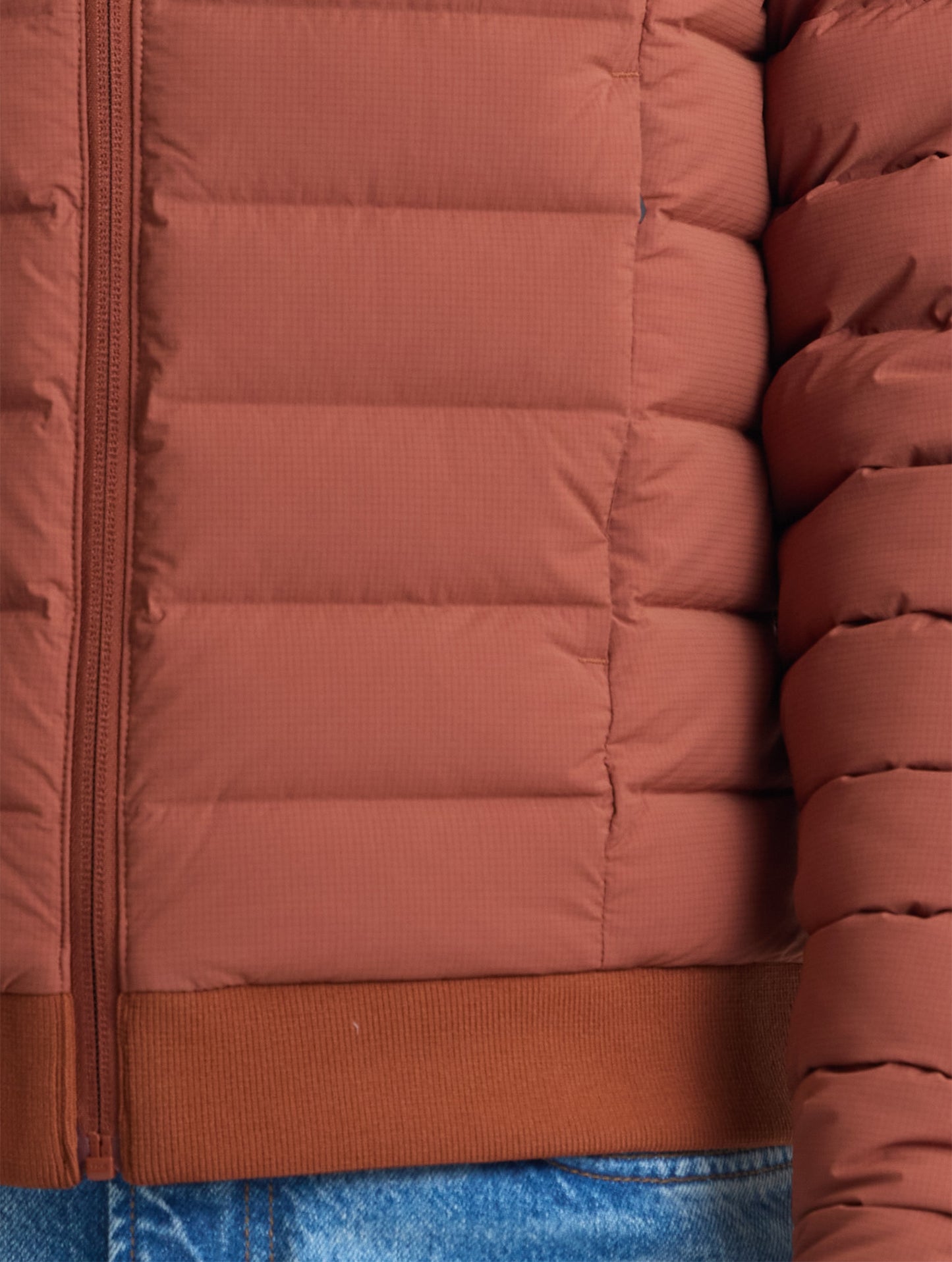 Closeup detail view of wearer's left pocket of W Launch Full-Zip Jacket NH in Redwood Rust from AETHER Apparel.