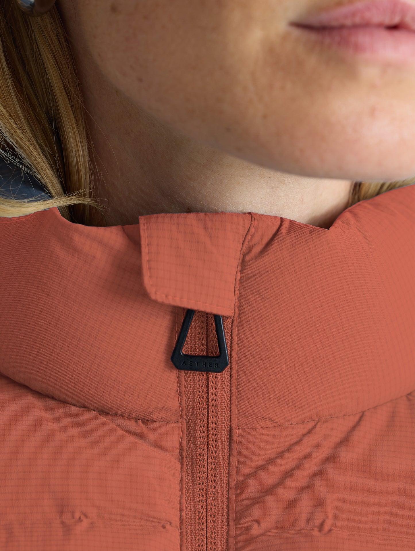 Closeup view of collar of Launch Full-Zip Jacket NH in Redwood Rust from AETHER Apparel.