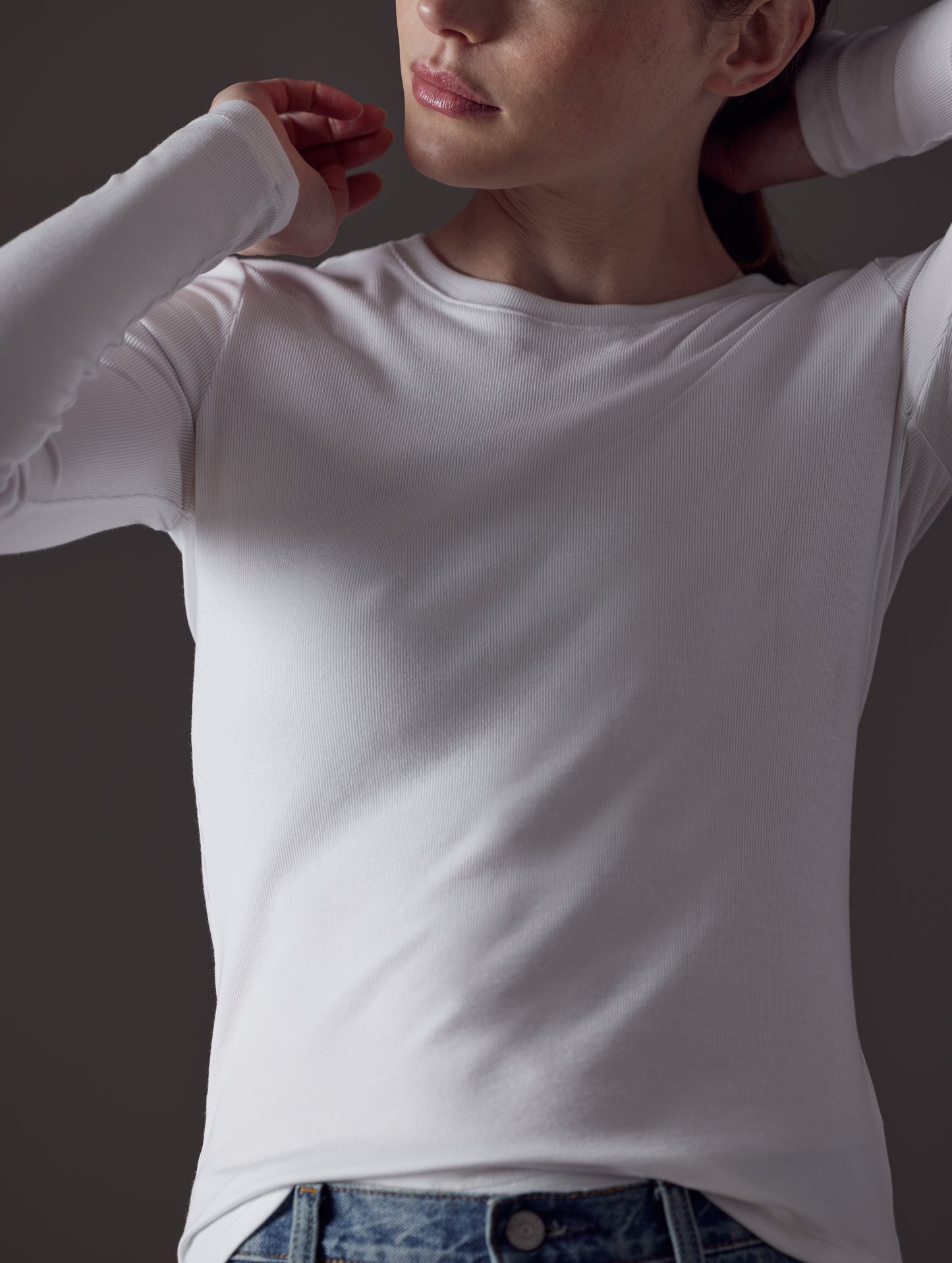 Closeup front view of woman wearing Legacy Long-Sleeve Crew in White from AETHER Apparel.