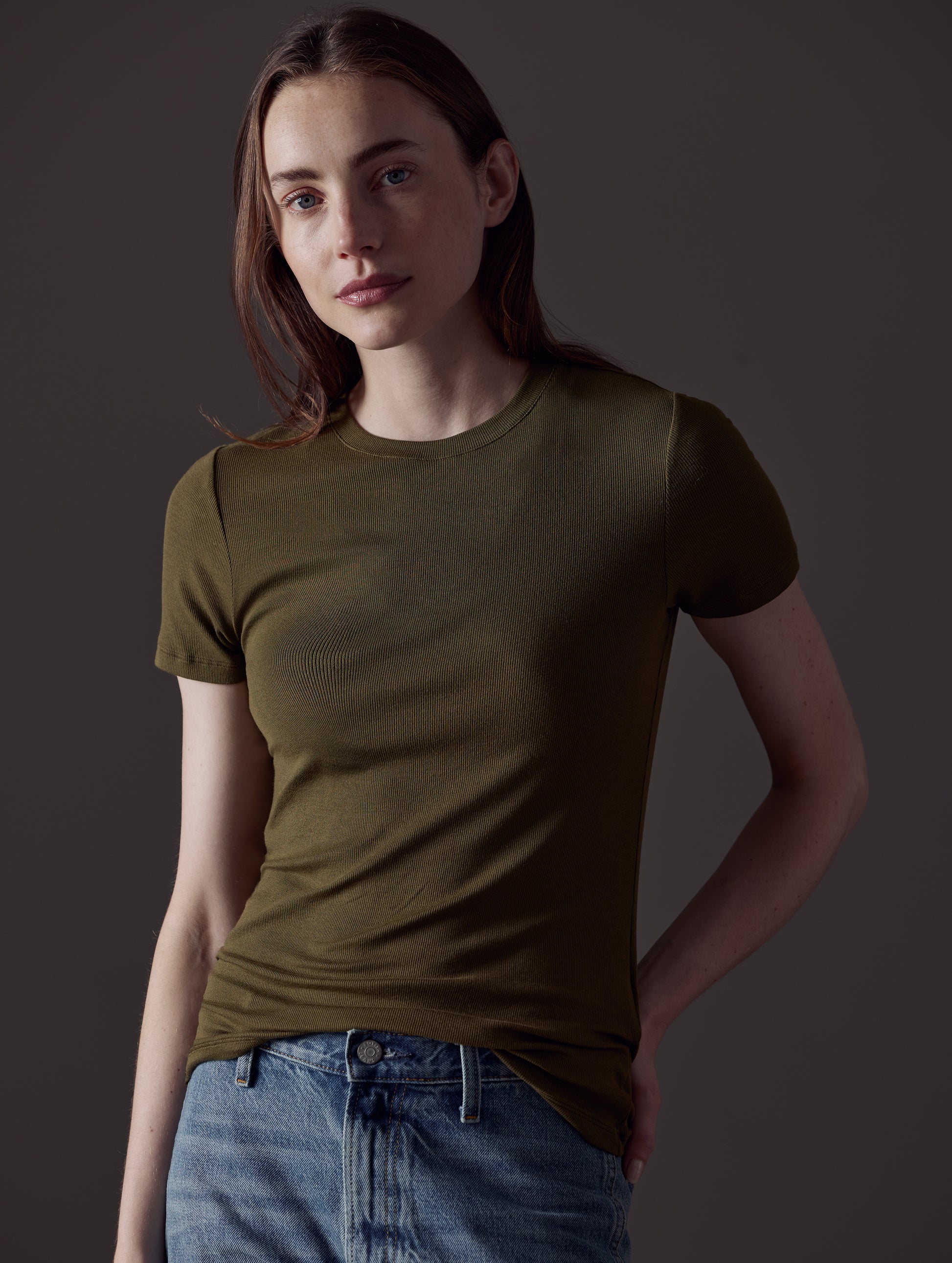 Front angled view of woman wearing Legacy Short-Sleeve Crew in Command Green from AETHER Apparel.