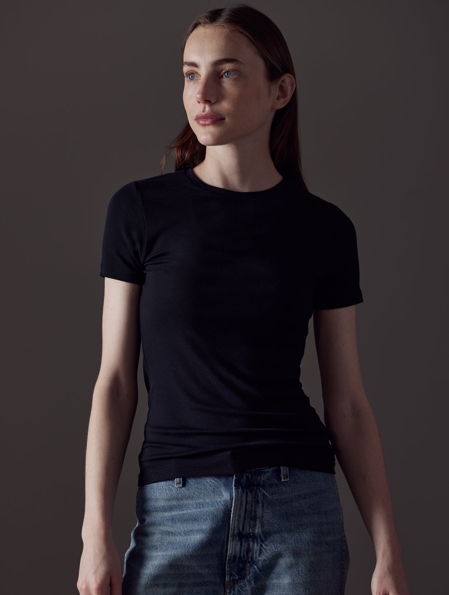 Front angled view of woman wearing Legacy Short-Sleeve Crew in Onyx Black from AETHER Apparel.