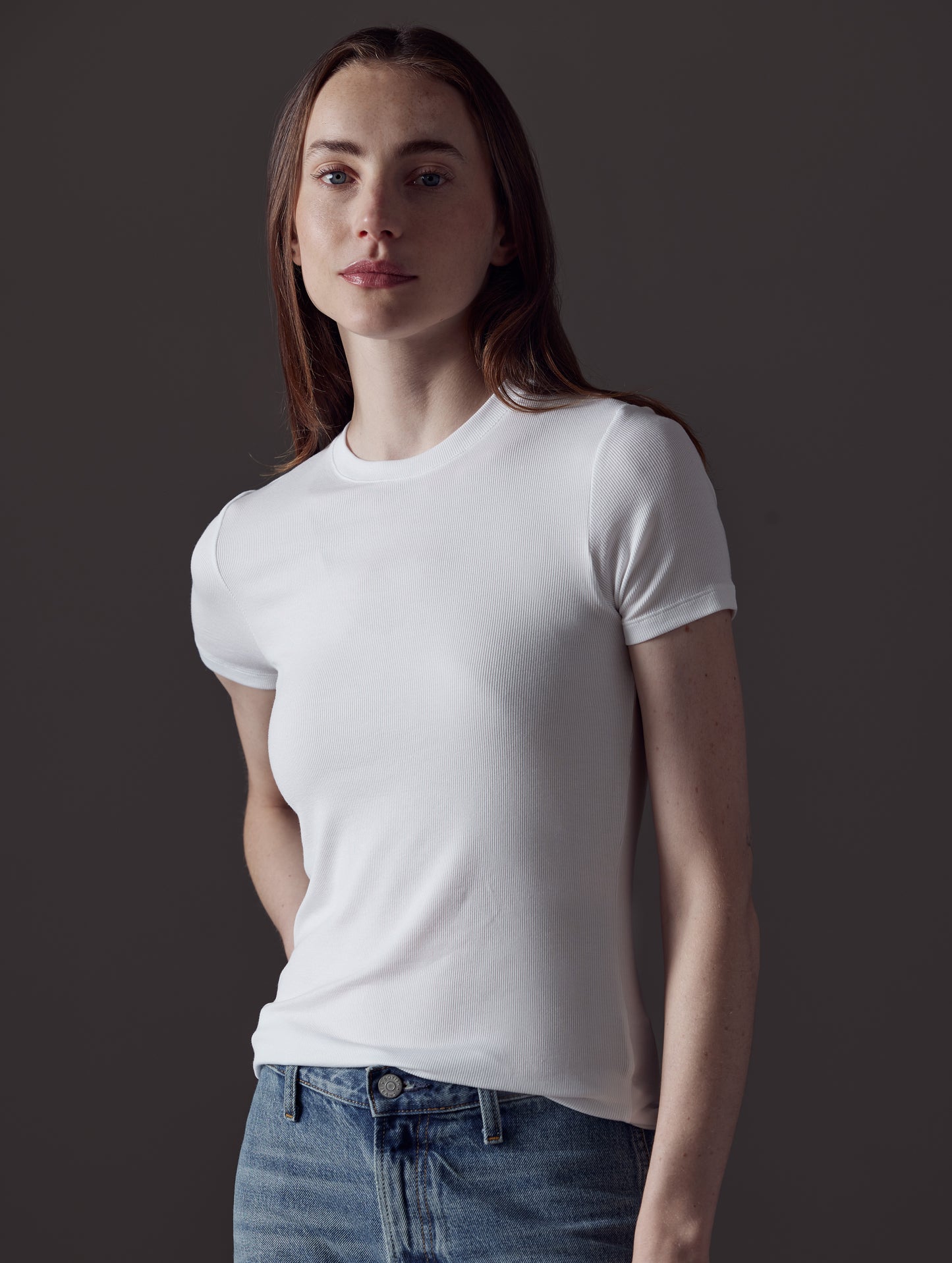 Front angled view of woman wearing Legacy Short-Sleeve Crew in White from AETHER Apparel.