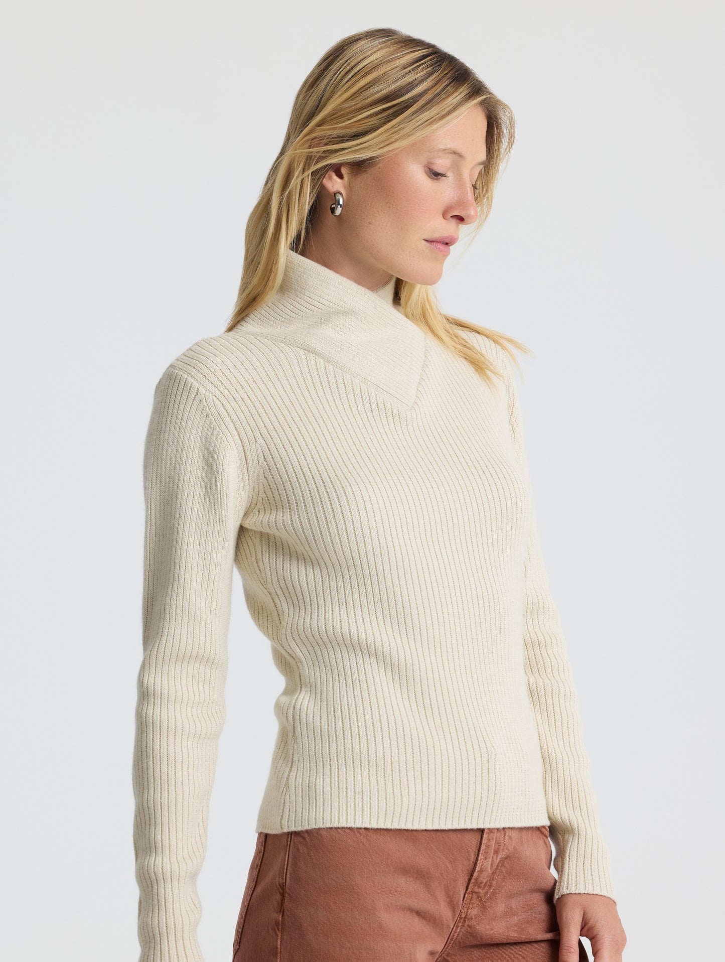 Angled upper body view of woman wearing Lexington Sweater in Bone white from AETHER Apparel.