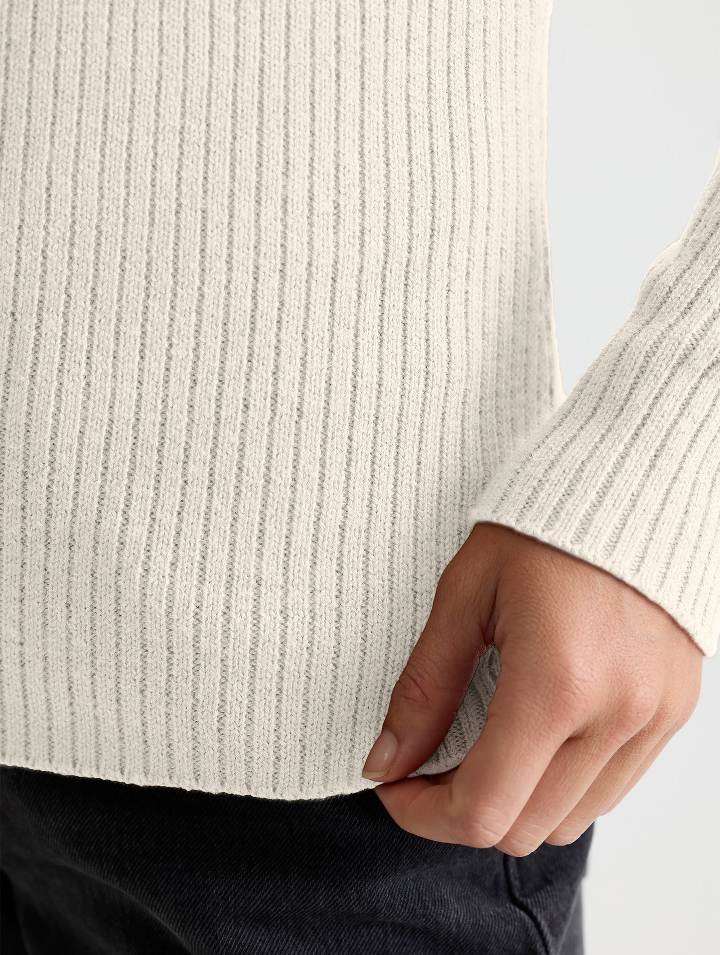 Closeup view of wearer's left sleeve of Lexington Sweater in Bone white from AETHER Apparel.