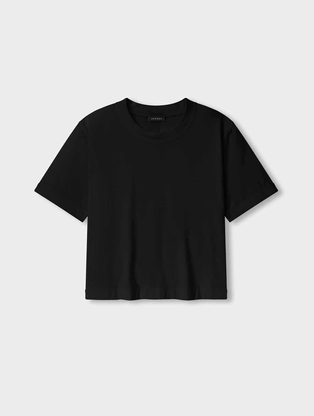 Flat lay view of the Lola Relaxed Tee in Onyx Black from AETHER Apparel.