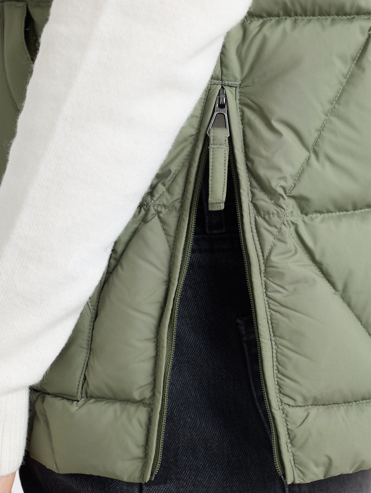 Closeup of bottom hem of Mailen Oversized Vest in Fern Green from AETHER Apparel.