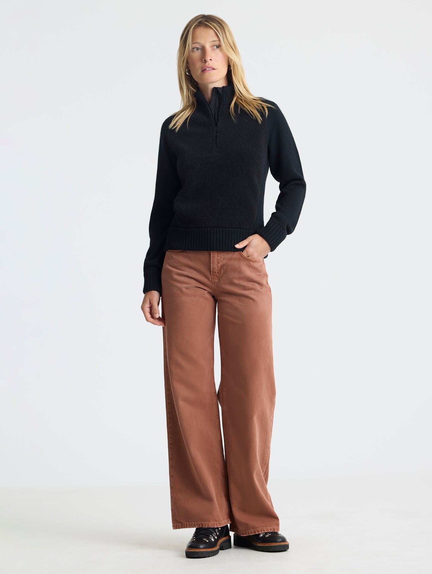 Full body view of woman wearing Malina Half-Zip Sweater in Onyx Black from AETHER Apparel.