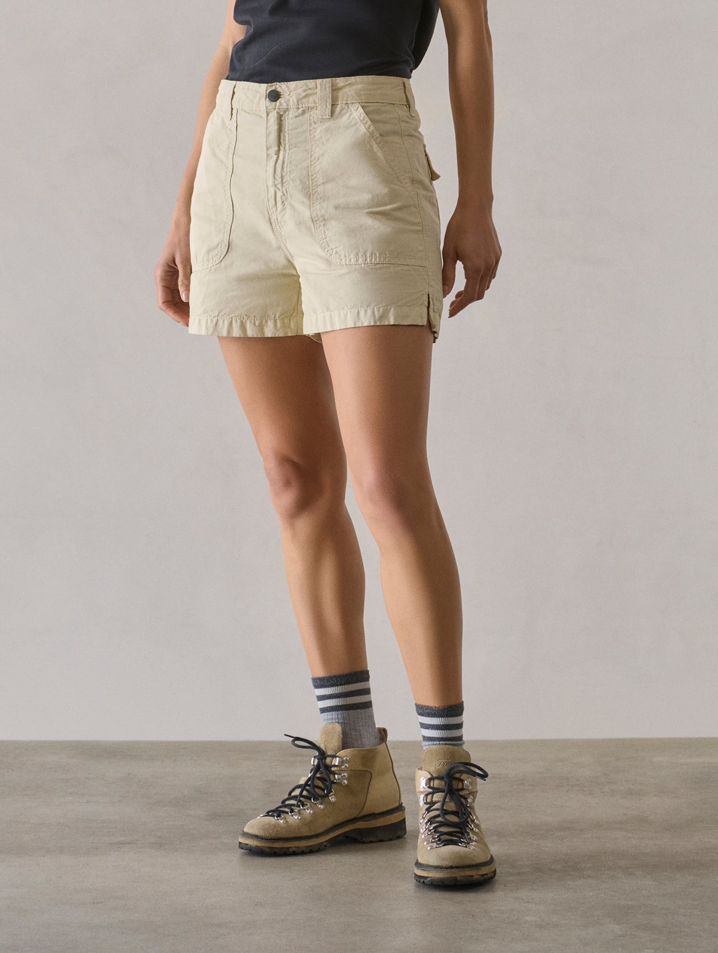 Front 3/4 lower body view of woman wearing Masai Safari Short in Bone white from AETHER Apparel.