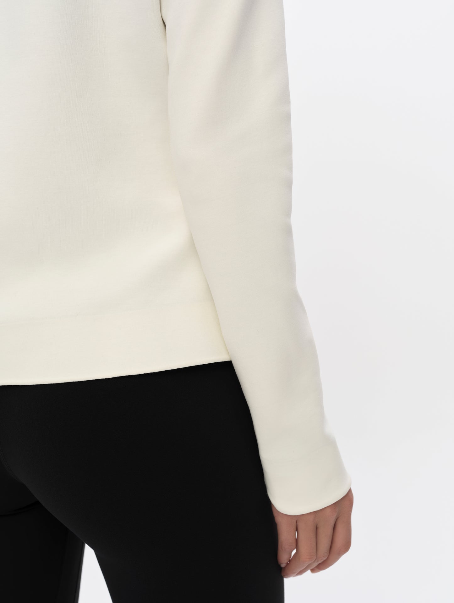 Closeup detailed view of hem and right cuff of the W Morgan Full-Zip 2.0 in Winter White from AETHER Apparel.