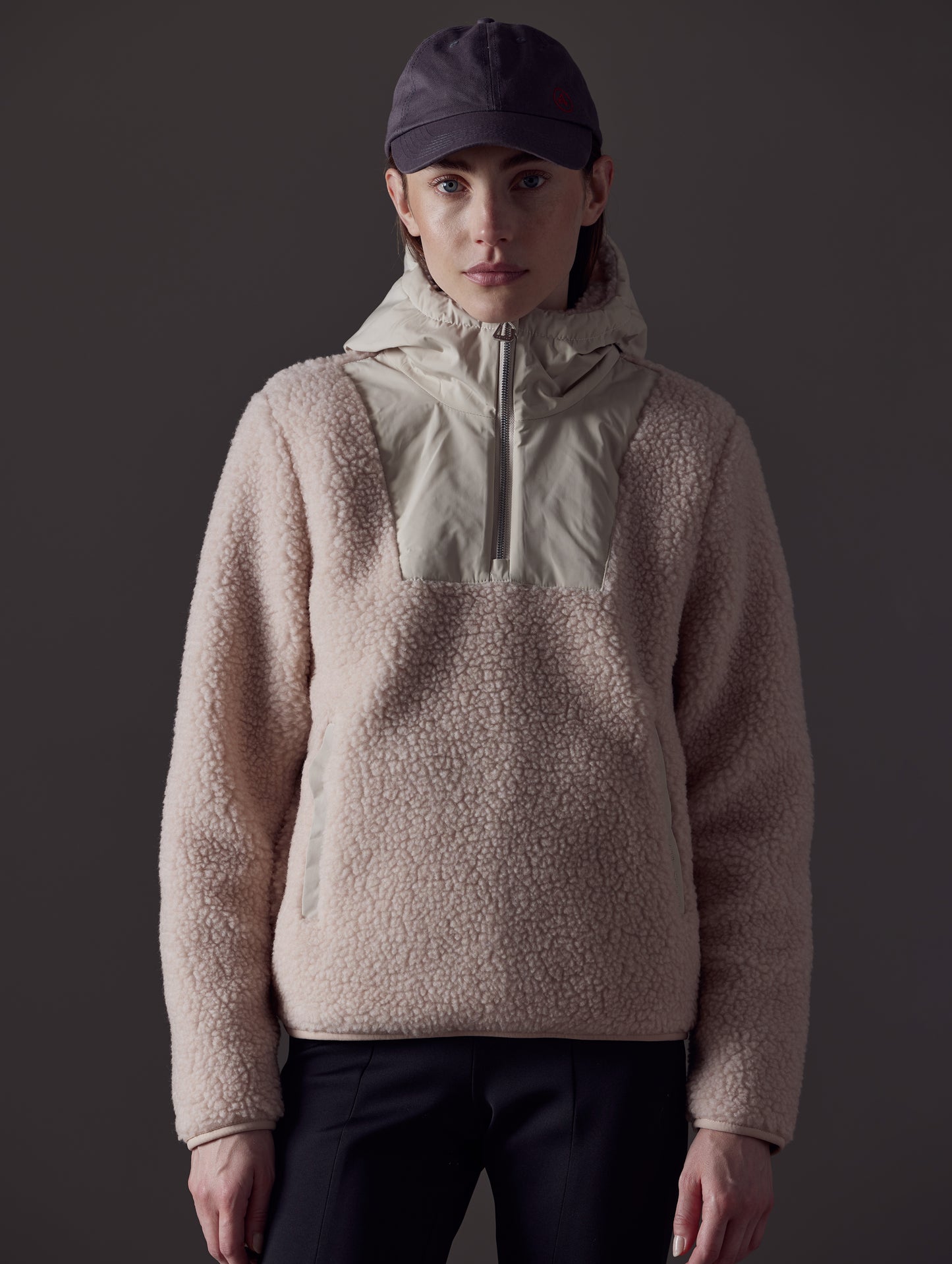 Upper body view of woman wearing pink Narrow Pullover from AETHER Apparel.