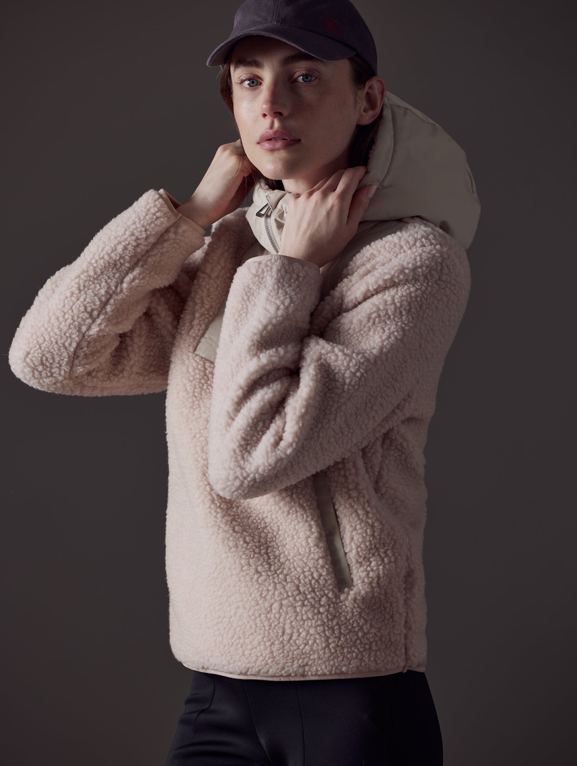 Angled view of woman wearing pink Narrow Pullover from AETHER Apparel.