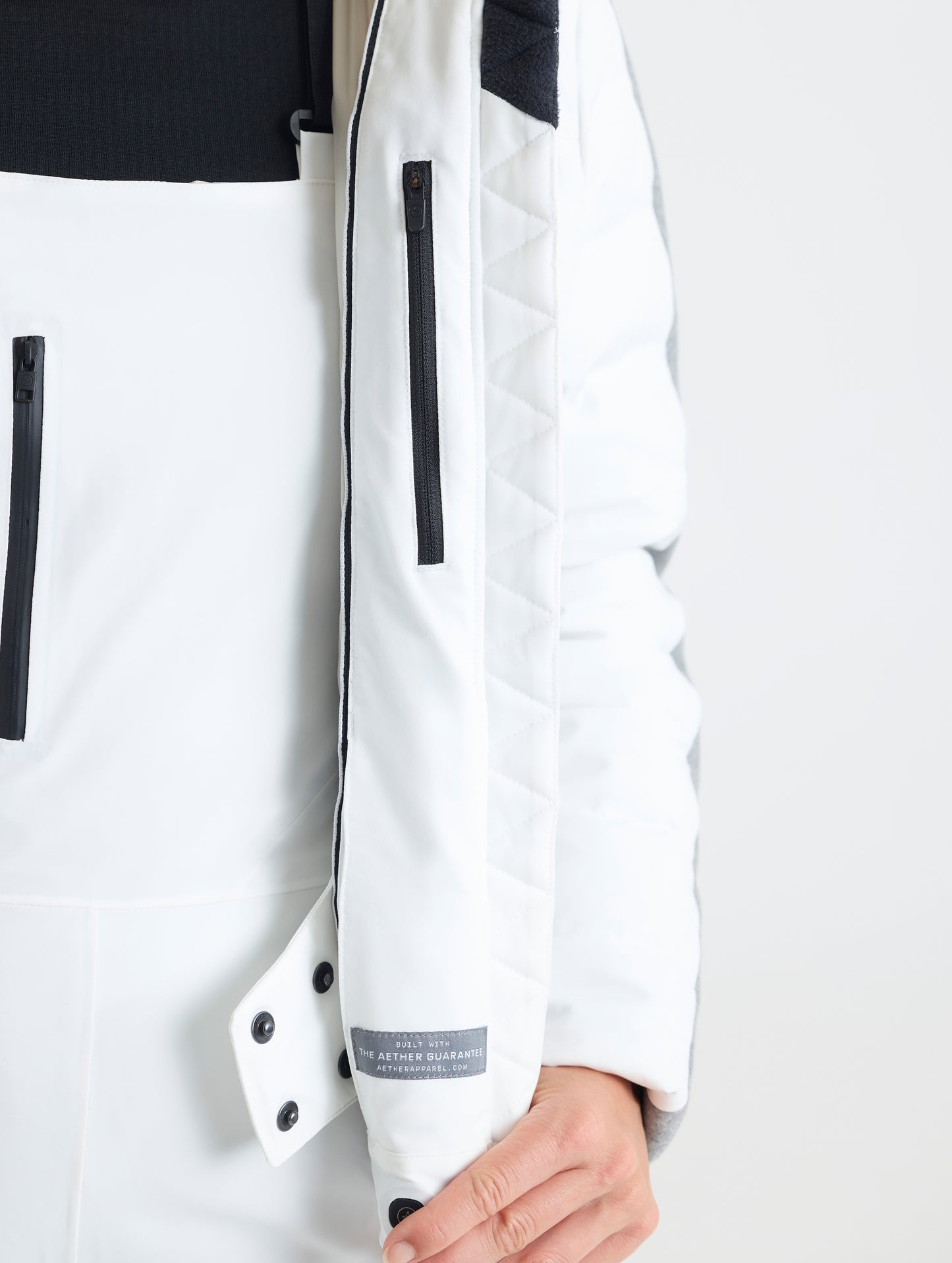 A closeup detailed view of the inner powder skirt and interior of the Nordic Jacket 2.0 in Winter White from AETHER Apparel.
