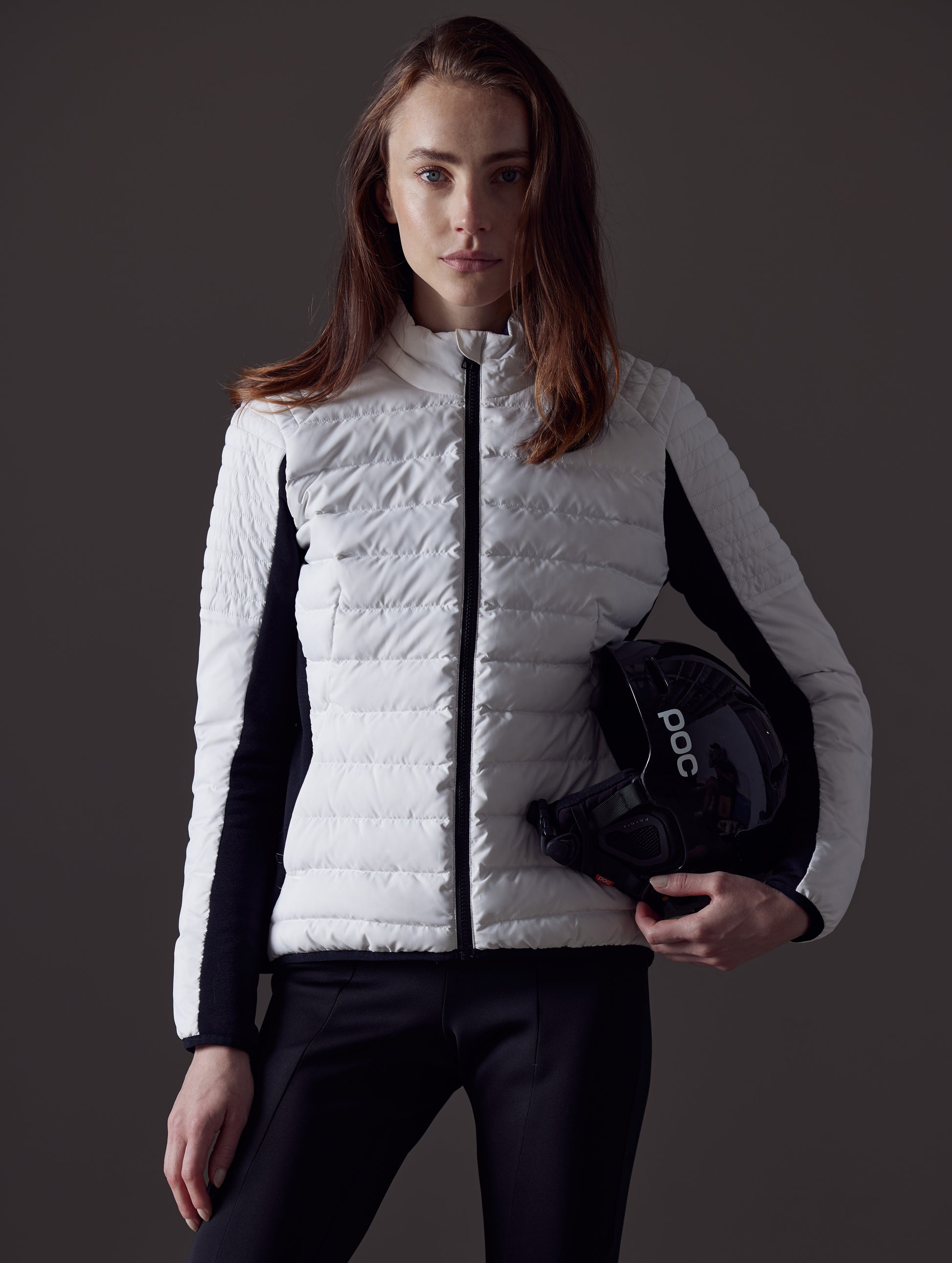 Woman wearing white quilted snow jacket from AETHER Apparel