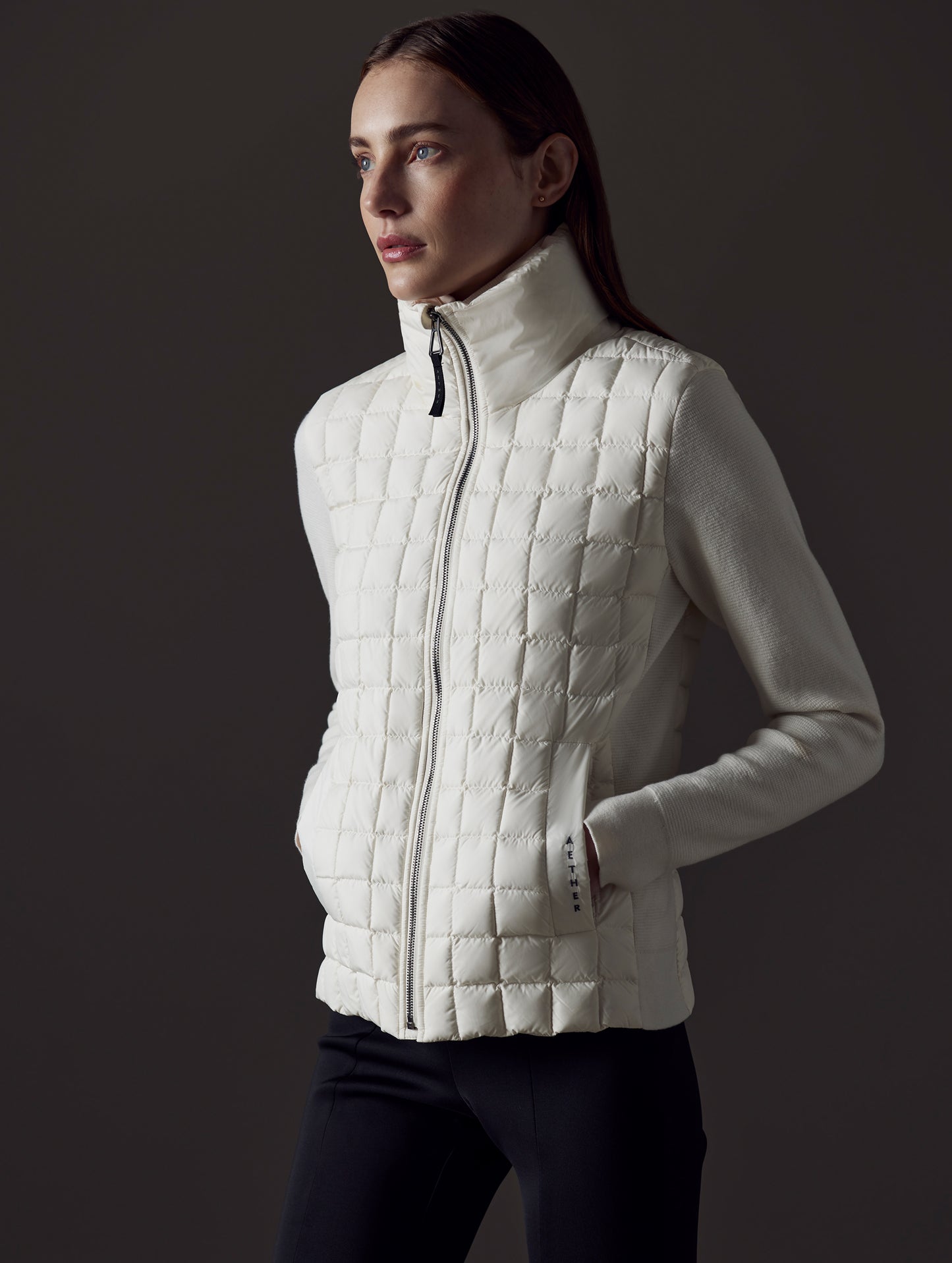 Front angled view of woman wearing Phase Full-Zip in Winter White from AETHER Apparel.